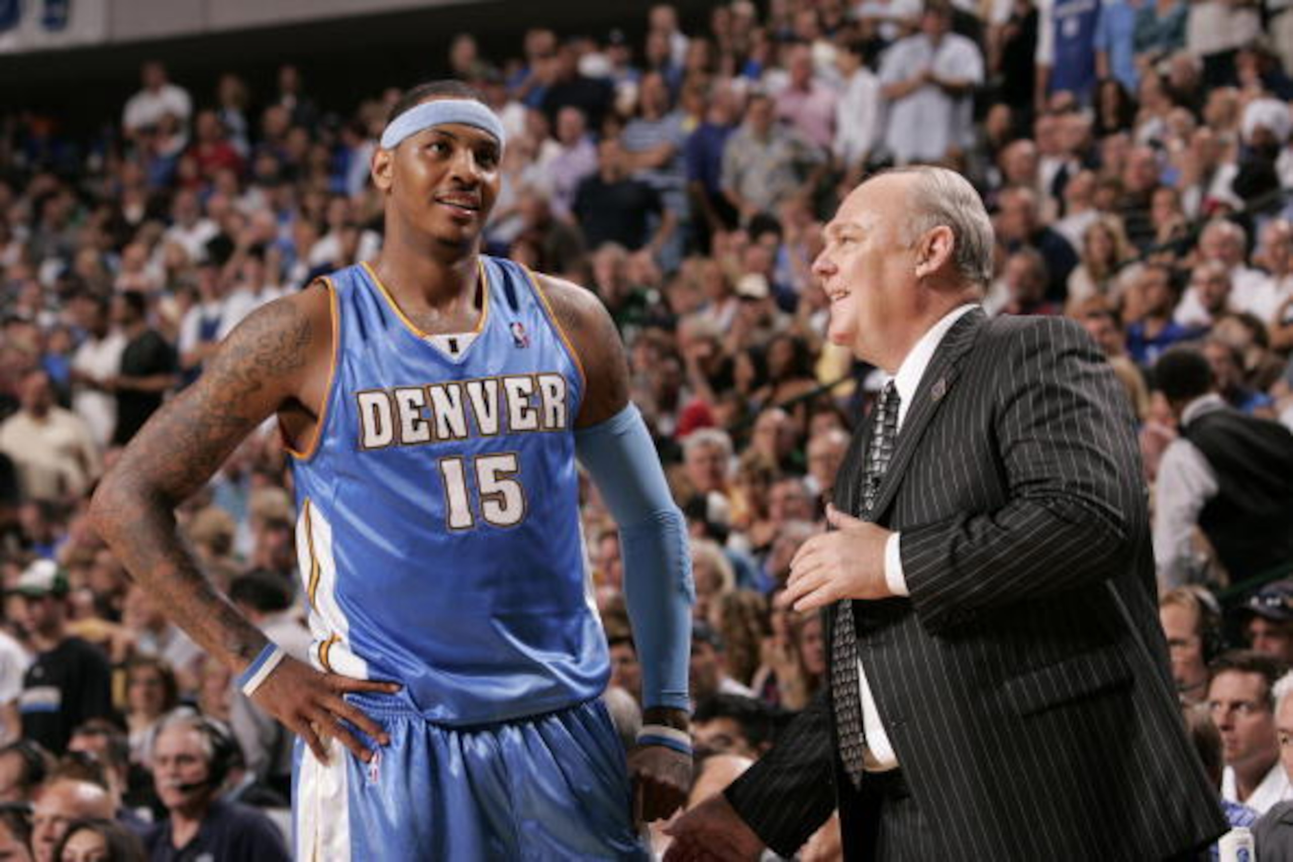 DALLAS - MAY 9: Carmelo Anthony #15 of the Denver Nuggets shares a chuckle with head coach George Karl against the Dallas Mavericks in Game Three of the Western Conference Semifinals during the 2009 NBA Playoffs at the American Airlines Center on May 9, 2 DALLAS - MAY 9: Carmelo Anthony #15 of the Denver Nuggets shares a chuckle with head coach George Karl against the Dallas Mavericks in Game Three of the Western Conference Semifinals during the 2009 NBA Playoffs at the American Airlines Center on May 9, 2