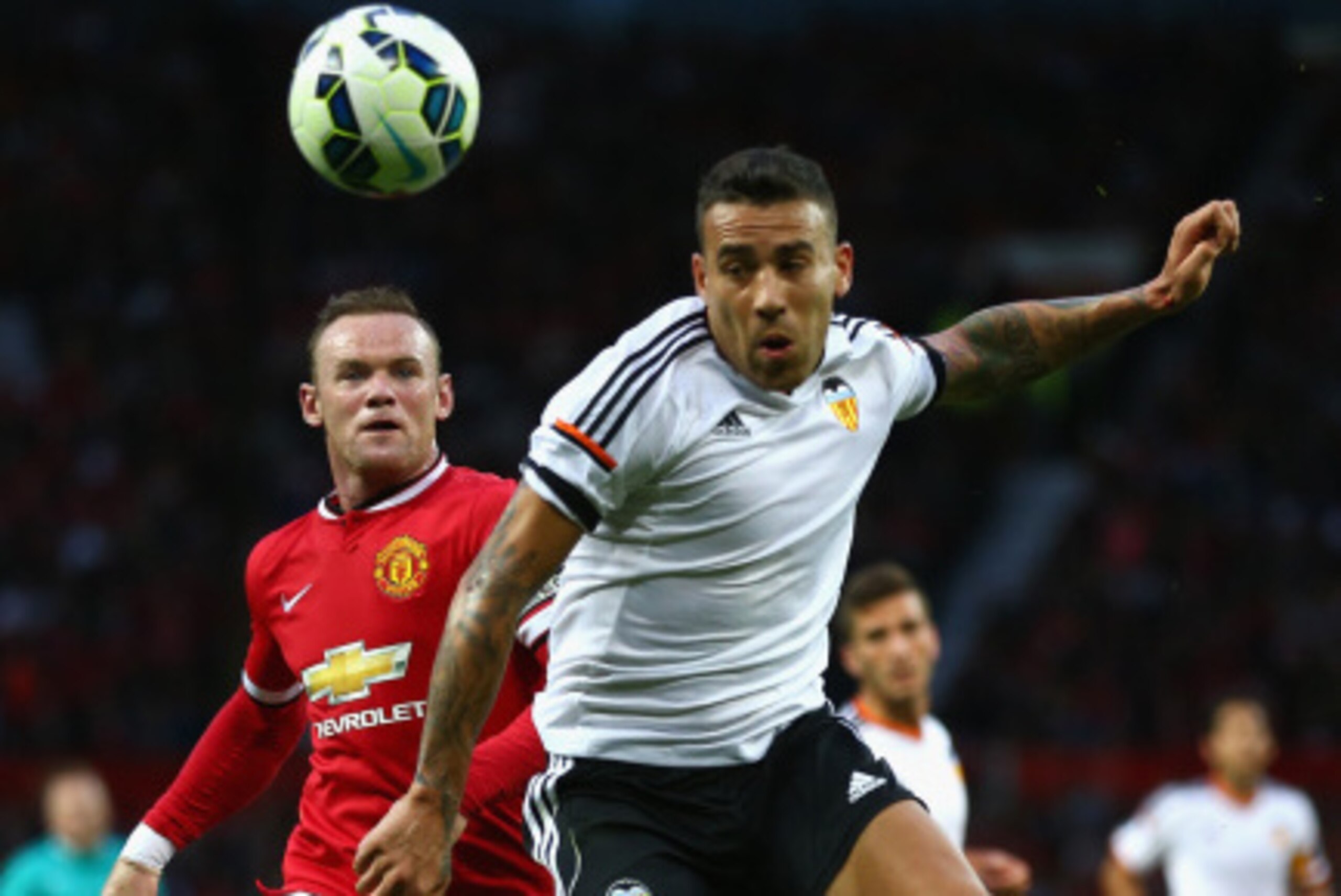 MANCHESTER, ENGLAND - AUGUST 12: Wayne Rooney of Manchester United in action with Nicolas Otamendi of Valencia during the Pre Season Friendly match between Manchester United and Valencia at Old Trafford on August 12, 2014 in Manchester, England. (Photo MANCHESTER, ENGLAND - AUGUST 12: Wayne Rooney of Manchester United in action with Nicolas Otamendi of Valencia during the Pre Season Friendly match between Manchester United and Valencia at Old Trafford on August 12, 2014 in Manchester, England. (Photo