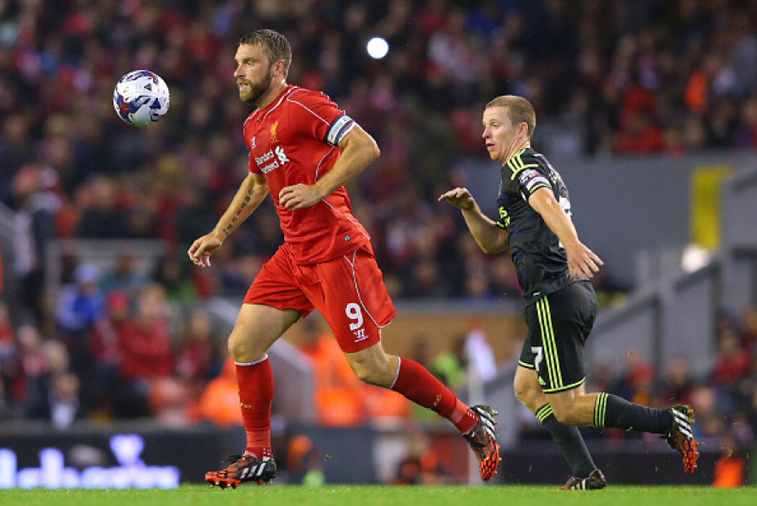 LIVERPOOL, ENGLAND - SEPTEMBER 23:  Rickie Lambert of Liverpool beats Grant Leadbitter of Middlesbrough during the Capital One Cup Third Round match between Liverpool and Middlesbrough at Anfield on September 23, 2014 in Liverpool, England.  (Photo by Ale