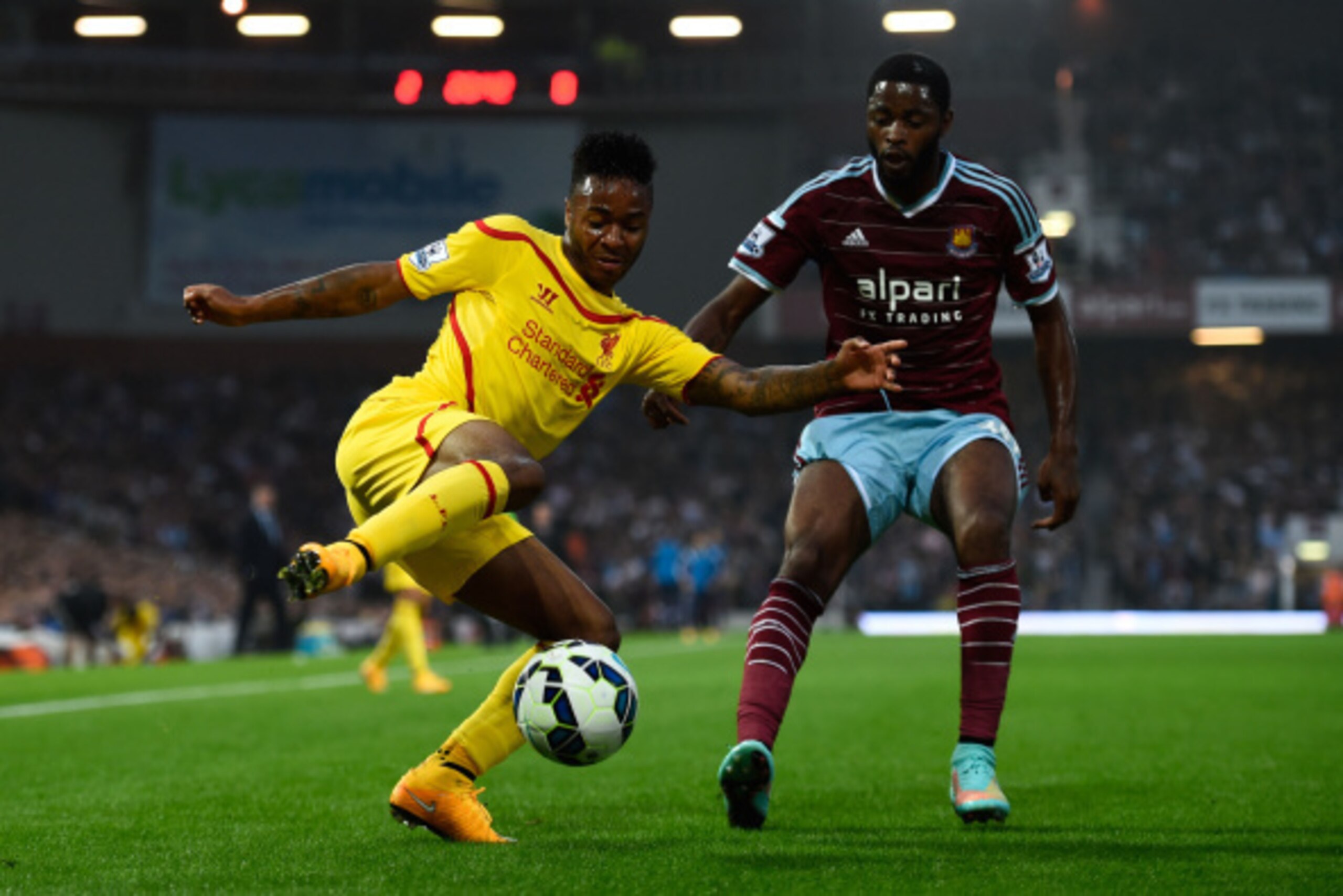 LONDON, ENGLAND - SEPTEMBER 20: Raheem Sterling of Liverpool is challenged by Alexandre Song of West Ham during the Barclays Premier League match between West Ham United and Liverpool at Boleyn Ground on September 20, 2014 in London, England. (Photo by LONDON, ENGLAND - SEPTEMBER 20: Raheem Sterling of Liverpool is challenged by Alexandre Song of West Ham during the Barclays Premier League match between West Ham United and Liverpool at Boleyn Ground on September 20, 2014 in London, England. (Photo by
