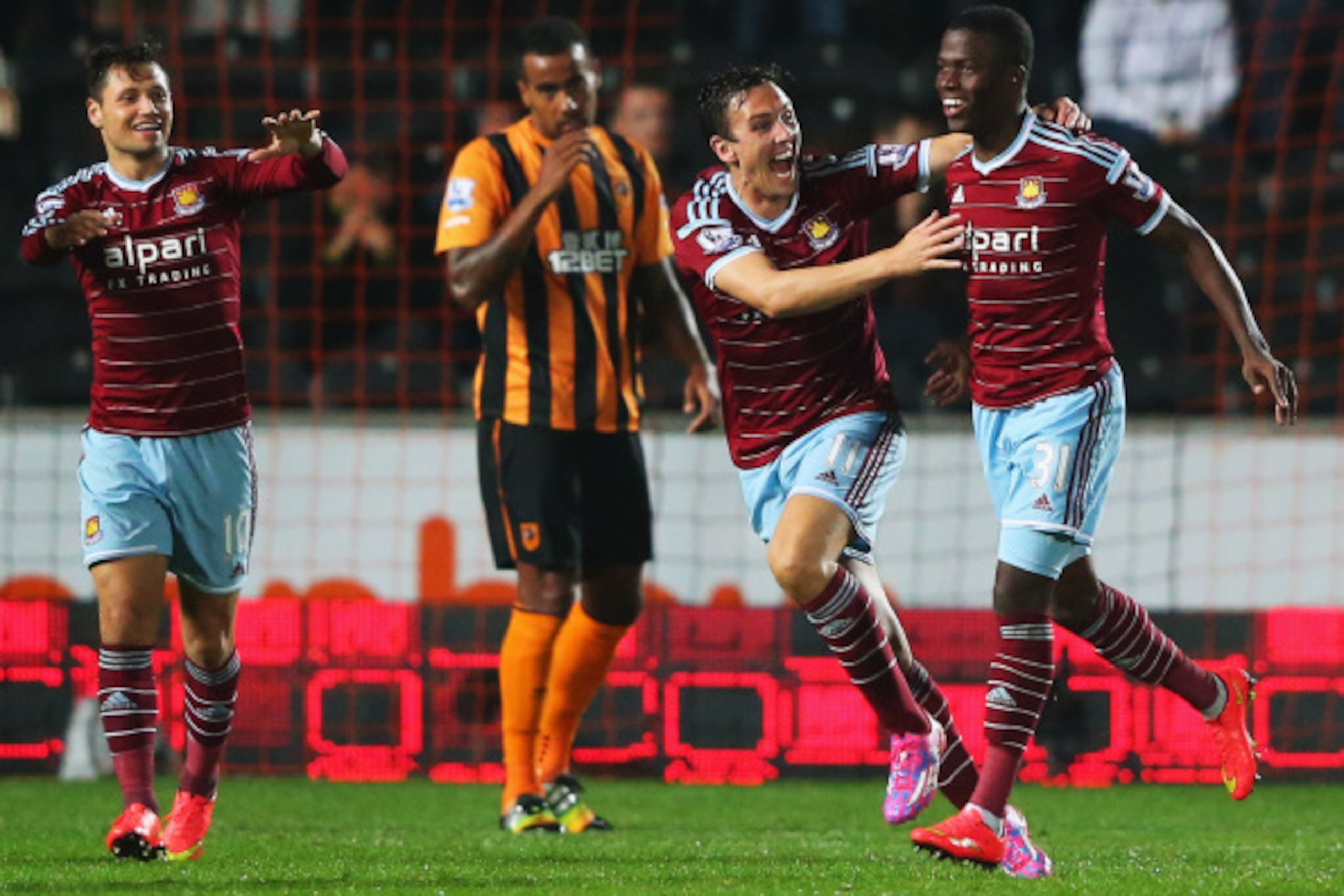 HULL, ENGLAND - SEPTEMBER 15:  Enner Valencia of West Ham United (31) celebrates with team mates Stewart Downing (11) and Mauro Zarate (10) as he scores their first goal during Barclays Premier League match between Hull City and West Ham United at KC Stad