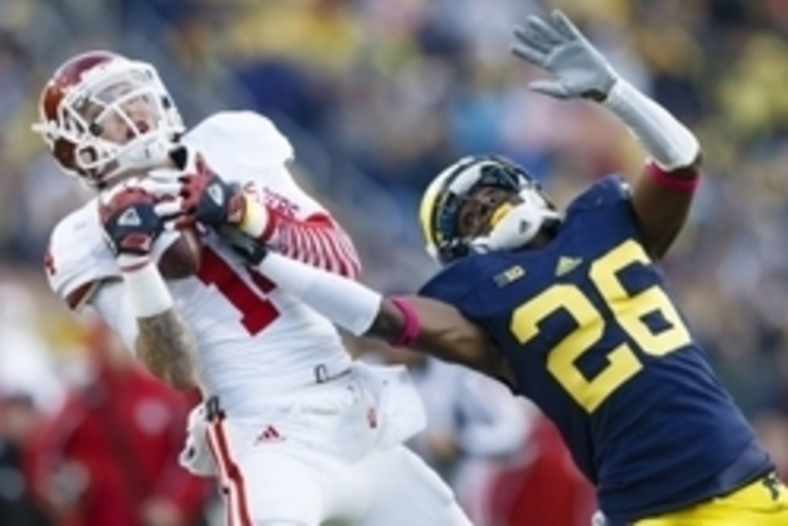 Oct 19, 2013; Ann Arbor, MI, USA; Indiana Hoosiers wide receiver Nick Stoner (14) makes a catch over Michigan Wolverines defensive back Jourdan Lewis (26) in the second half at Michigan Stadium. Michigan won 63-47. Mandatory Credit: Rick Osentoski-USA TOD