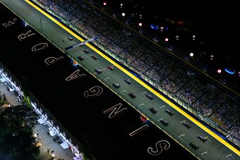 SINGAPORE - SEPTEMBER 21:  Lewis Hamilton of Great Britain and Mercedes GP leads the field into the first corner during the Singapore Formula One Grand Prix at Marina Bay Street Circuit on September 21, 2014 in Singapore, Singapore.  (Photo by Dan Istiten