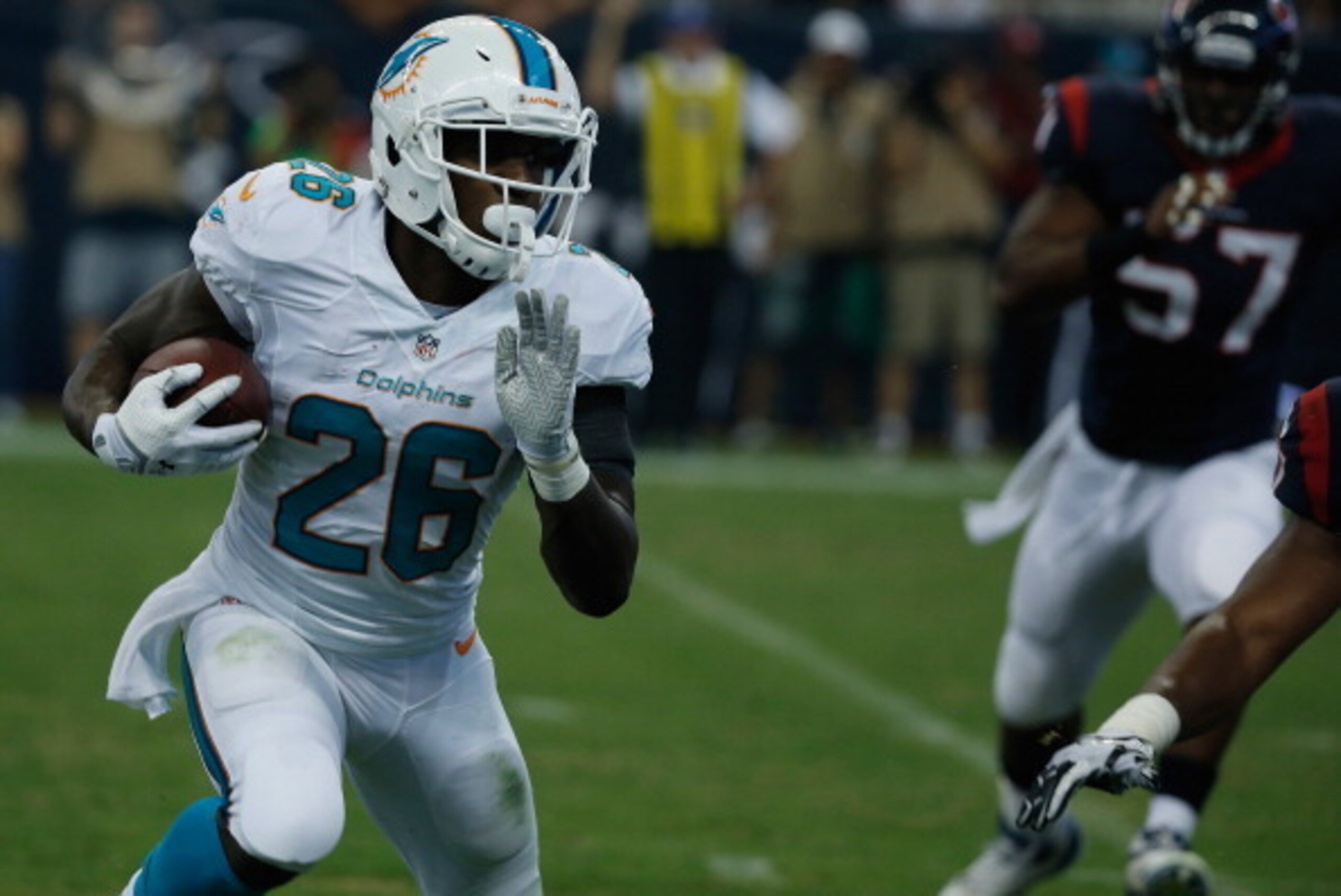 HOUSTON, TX - AUGUST 17:  Lamar Miller #26 of the Miami Dolphins runs for a 4-yard touchdown in the first half against the Houston Texans during a preseaon game at Reliant Stadium on August 17, 2013 in Houston, Texas.  (Photo by Scott Halleran/Getty Image