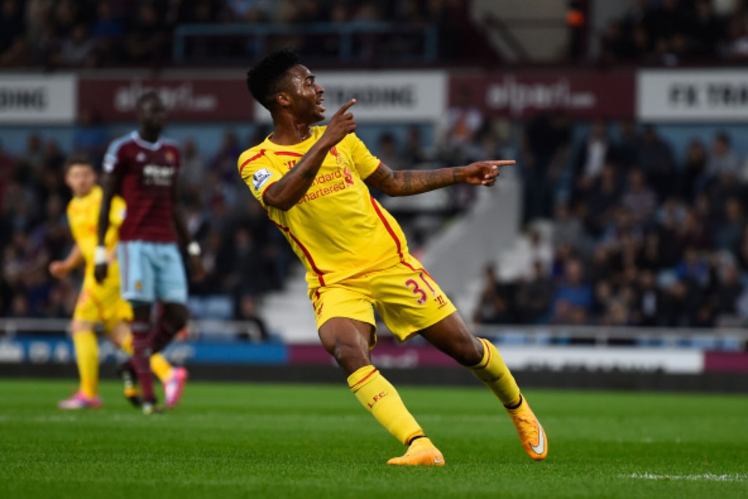LONDON, ENGLAND - SEPTEMBER 20:  Raheem Sterling of Liverpool turns away to celebrate after scoring his team's first goal during the Barclays Premier League match between West Ham United and Liverpool at Boleyn Ground on September 20, 2014 in London, Engl