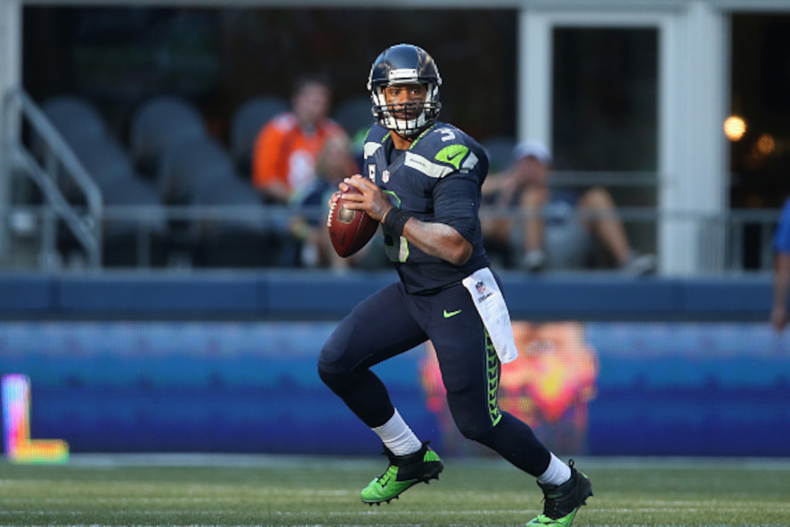 SEATTLE, WA - SEPTEMBER 21:  Quarterback Russell Wilson #3 of the Seattle Seahawks runs with the ball against the Denver Broncos at CenturyLink Field on September 21, 2014 in Seattle, Washington.  (Photo by Jeff Gross/Getty Images)