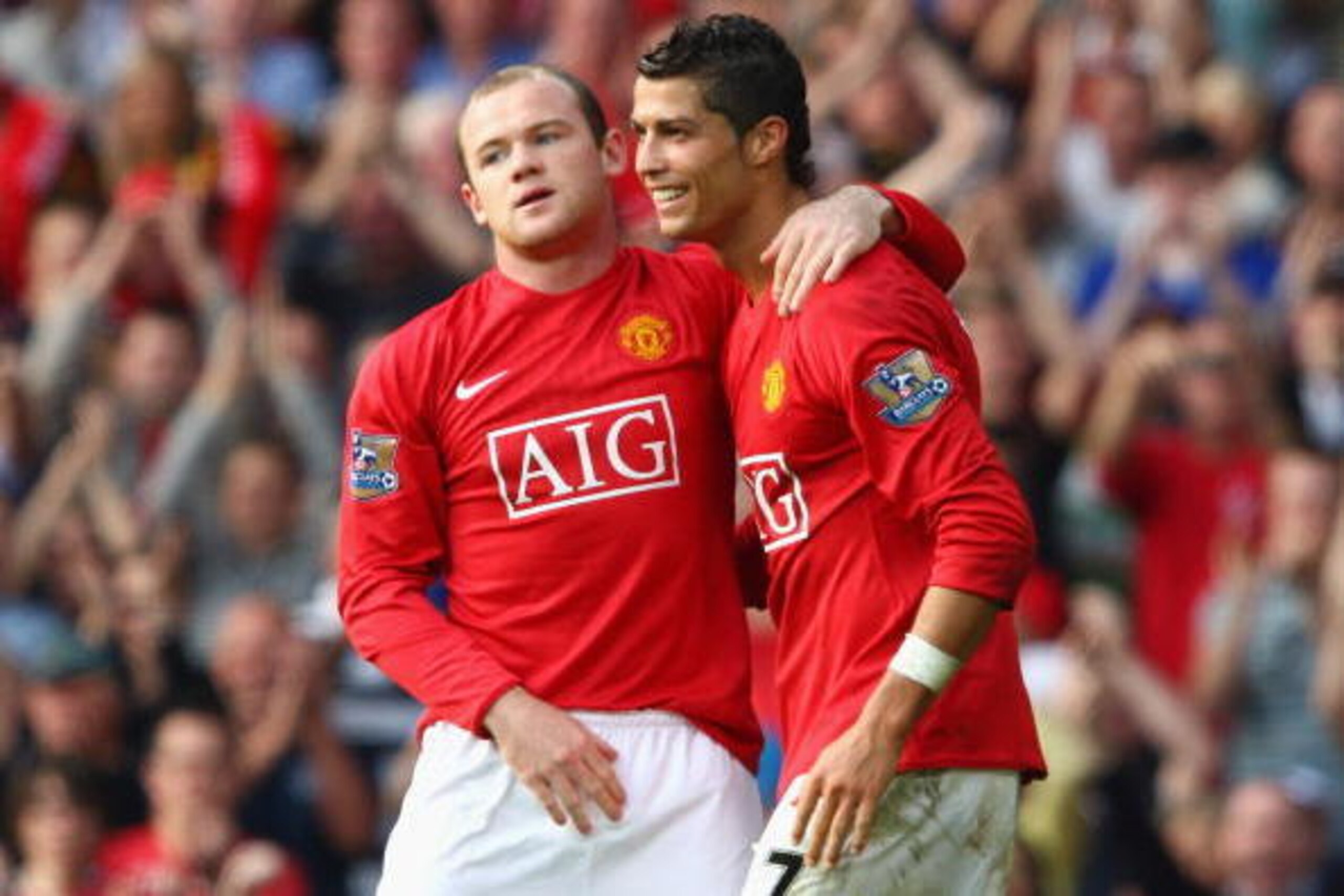 MANCHESTER, UNITED KINGDOM - SEPTEMBER 27:  Wayne Rooney of Manchester United celebrates scoring his team's second goal with team mate Cristiano Ronaldo (R) during the Barclays Premier League match between Manchester United and Bolton Wanderers at Old Tra
