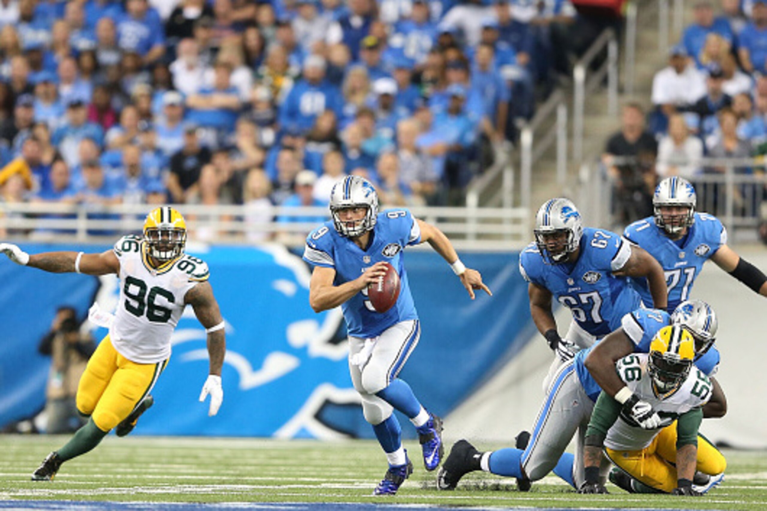 DETROIT, MI - SEPTEMBER 21: Quarterback Matthew Stafford #9 of the Detroit Lions runs for a short gain during the first quarter of the game against the Green Bay Packers at Ford Field on September 21, 2014 in Detroit, Michigan.  (Photo by Leon Halip/Getty