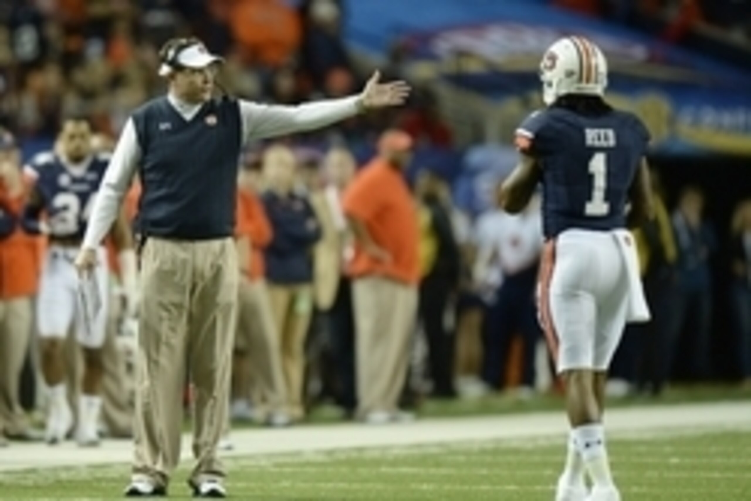 Dec 7, 2013; Atlanta, GA, USA; Auburn Tigers head coach Gus Malzahn speaks to Auburn Tigers wide receiver Trovon Reed (1) during the third quarter of the 2013 SEC Championship game against the Missouri Tigers at Georgia Dome. Mandatory Credit: Kevin Liles