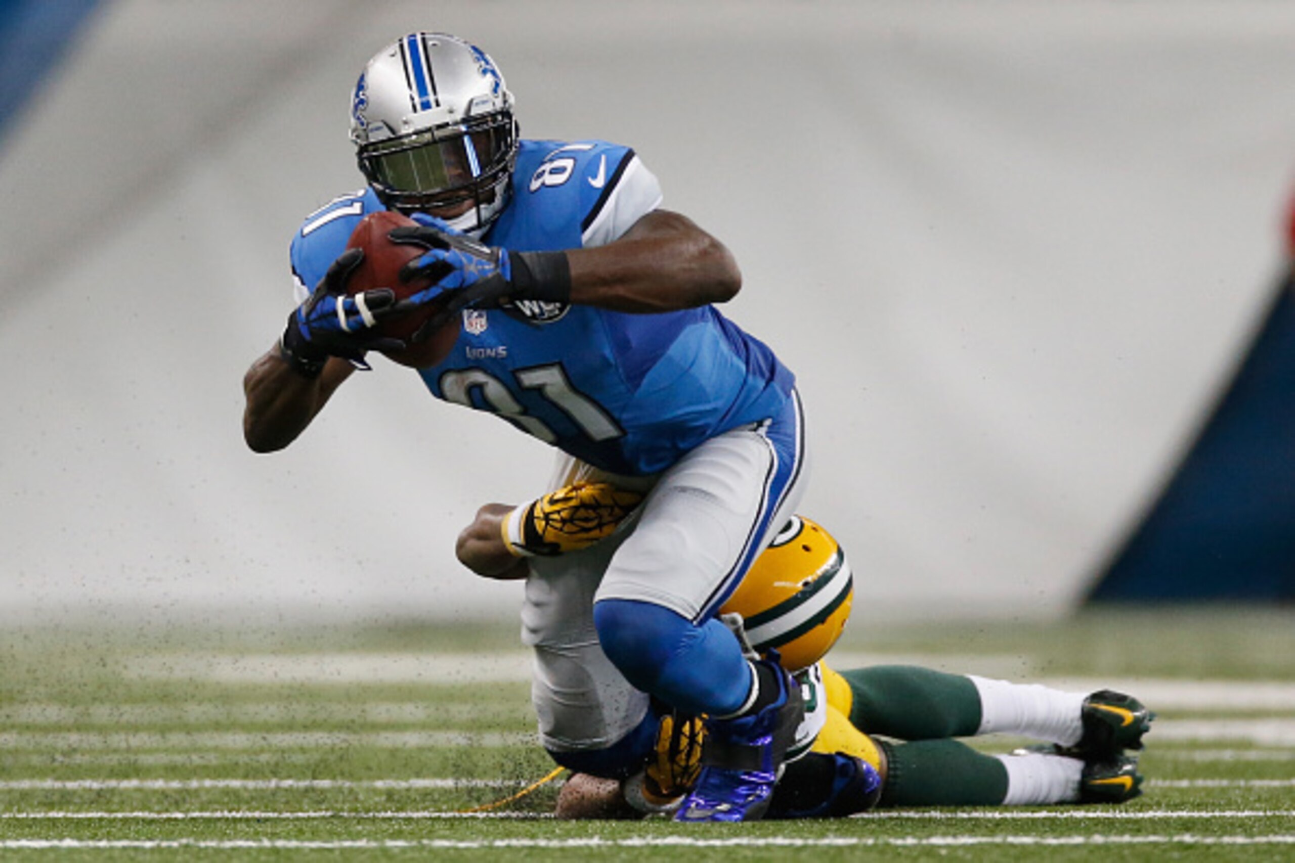 DETROIT, MI - SEPTEMBER 21: Calvin Johnson #81 of the Detroit Lions tires to avoid the tackle in the third quarter while playing the Green Bay Packers at Ford Field on September 21, 2014 in Detroit, Michigan. (Photo by Gregory Shamus/Getty Images)