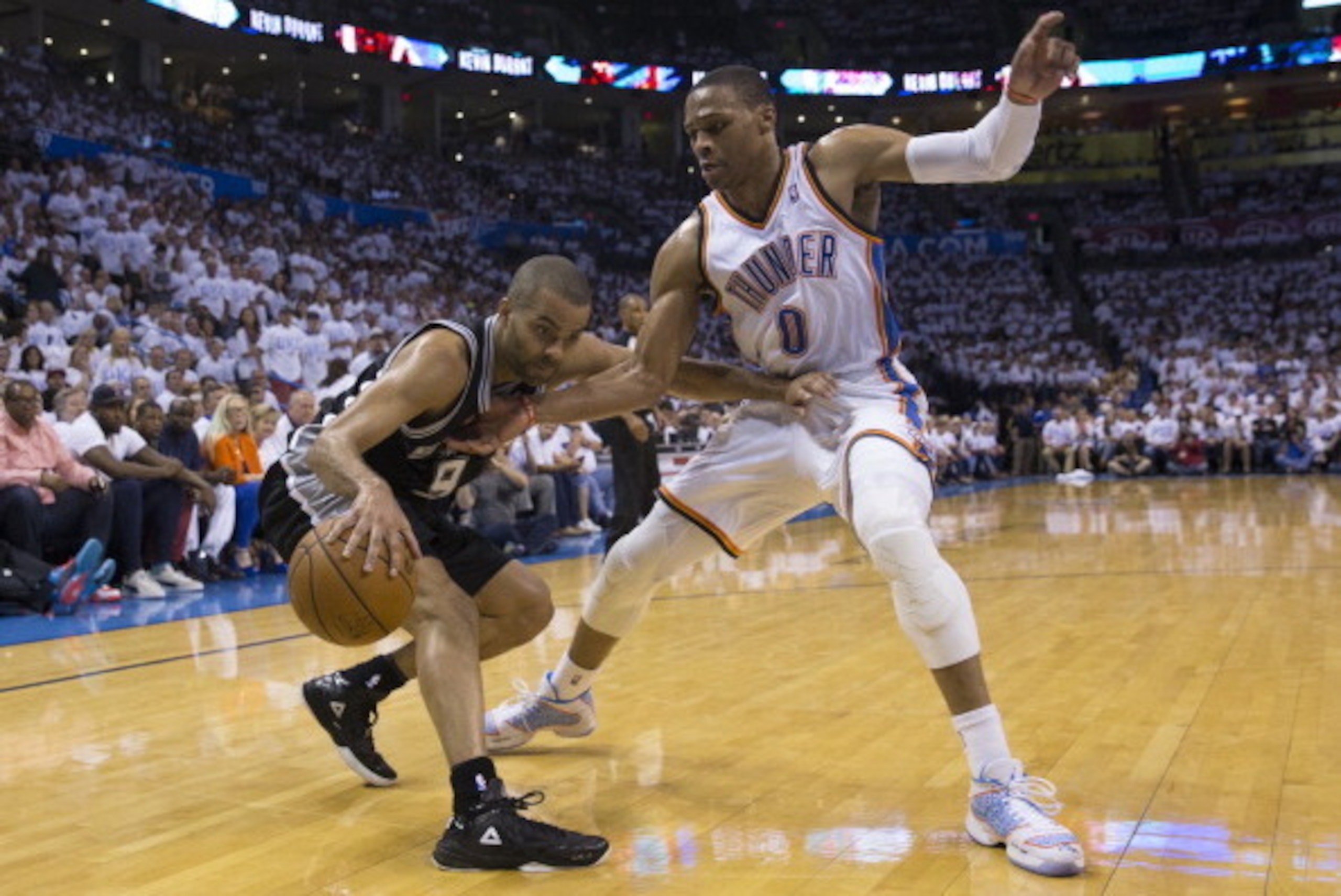 OKLAHOMA CITY, OK - May 31: Tony Parker #9 of the San Antonio Spurs drives against Russell Westbrook #0 of the Oklahoma City Thunder in Game 6 of the Western Conference Finals during the 2014 NBA Playoffs at the Chesapeake Energy Arena on May 31, 2014 in OKLAHOMA CITY, OK - May 31: Tony Parker #9 of the San Antonio Spurs drives against Russell Westbrook #0 of the Oklahoma City Thunder in Game 6 of the Western Conference Finals during the 2014 NBA Playoffs at the Chesapeake Energy Arena on May 31, 2014 in
