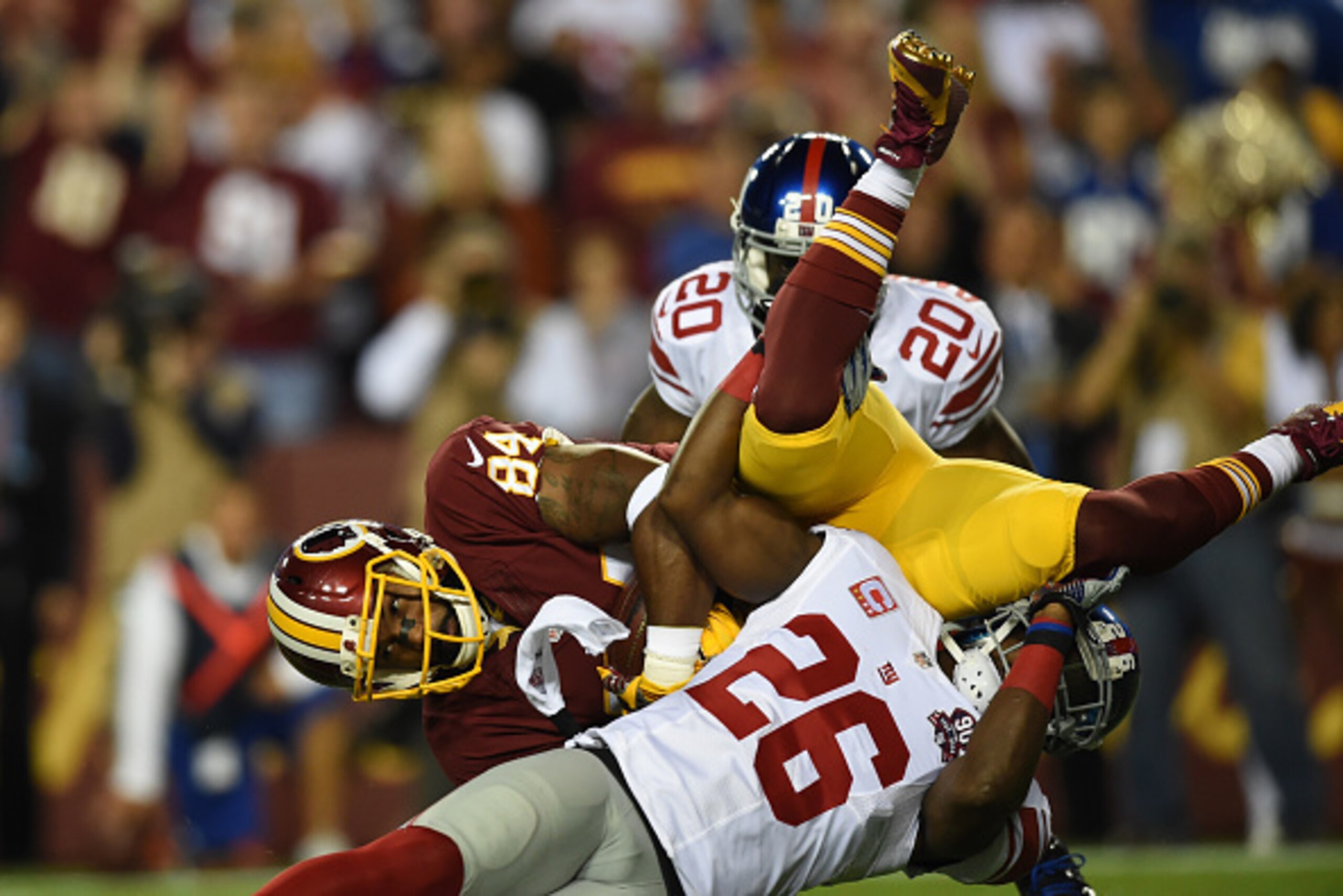 LANDOVER, MD - SEPTEMBER 25: Tight end Niles Paul #84 of the Washington Redskins is upended during their game against the New York Giants at FedExField on September 25, 2014 in Landover, Maryland. (Photo by Patrick Smith/Getty Images)