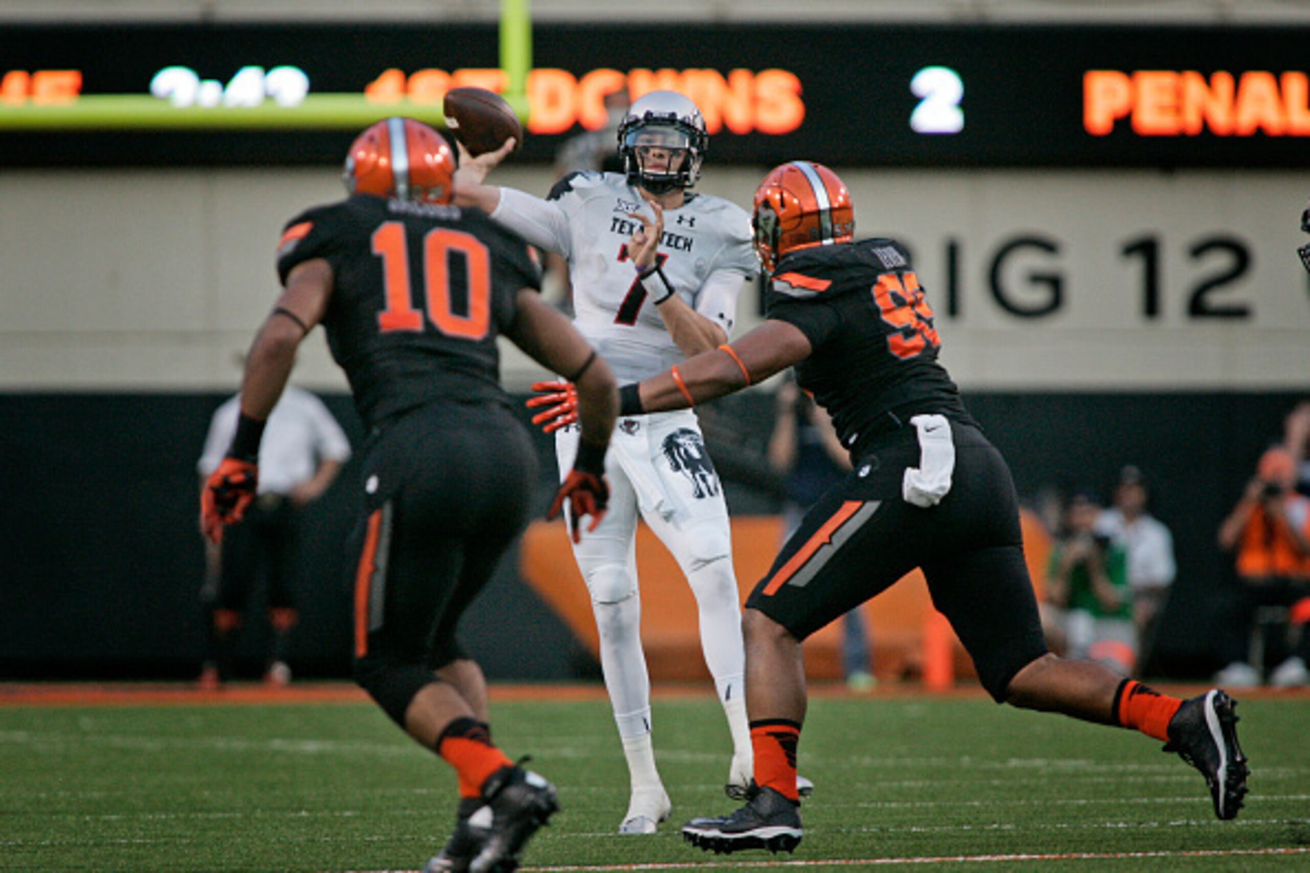 STILLWATER, OK - SEPTEMBER 25:   Quarterback Davis Webb #7 of the Texas Tech Red Raiders looks to throw under pressure against the Oklahoma State Cowboys September 25, 2014 at Boone Pickens Stadium in Stillwater, Oklahoma.  (Photo by Brett Deering/Getty I