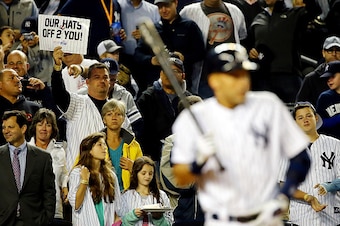 NEW YORK, NY - SEPTEMBER 25:  Derek Jeter #2 of the New York Yankees bats as a fan holds up a sign behind him against the Baltimore Orioles during a game at Yankee Stadium on September 25, 2014 in the Bronx borough of New York City.  (Photo by Al Bello/Ge
