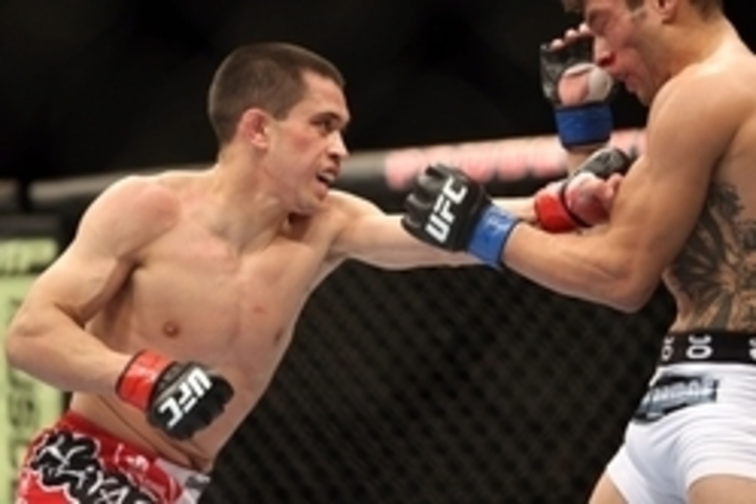 Feb 1, 2014; Newark, NJ, USA; Chris Cariaso (red gloves) fights Danny Martinez (blue gloves) during UFC 169 at Prudential Center. Mandatory Credit: Joe Camporeale-USA TODAY Sports