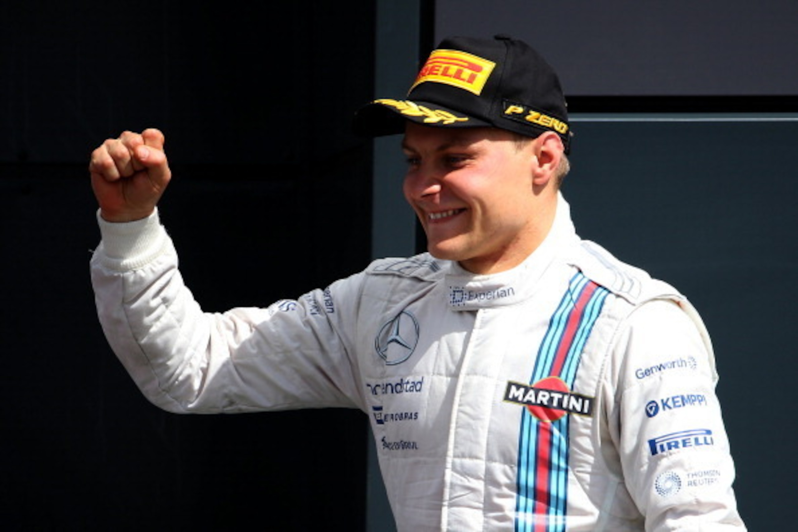 NORTHAMPTON, ENGLAND - JULY 06:  Valtteri Bottas of Finland and Williams celebrates on the podium after finishing second in the British Formula One Grand Prix at Silverstone Circuit on July 6, 2014 in Northampton, United Kingdom.  (Photo by Mark Thompson/