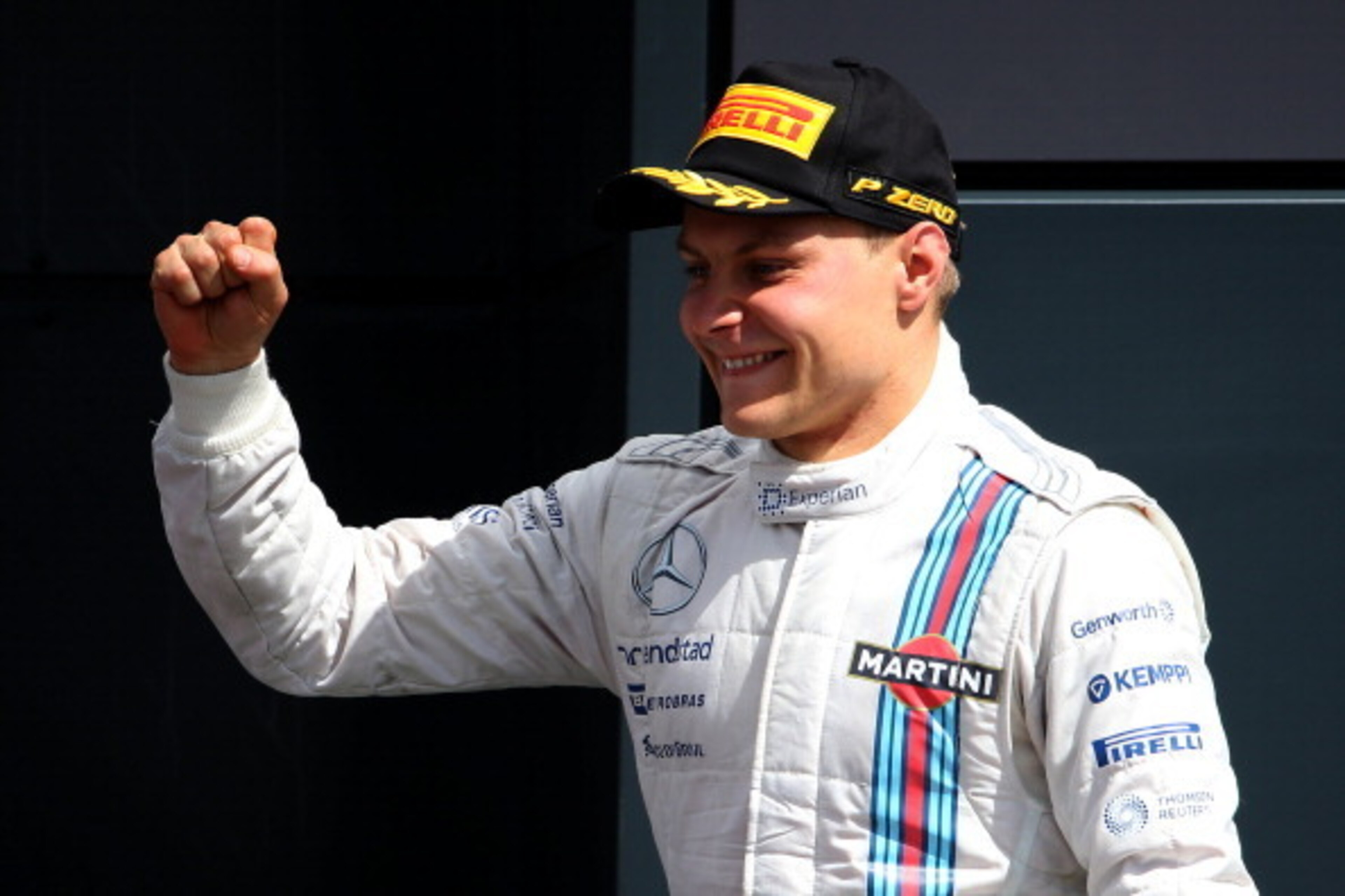 NORTHAMPTON, ENGLAND - JULY 06:  Valtteri Bottas of Finland and Williams celebrates on the podium after finishing second in the British Formula One Grand Prix at Silverstone Circuit on July 6, 2014 in Northampton, United Kingdom.  (Photo by Mark Thompson/