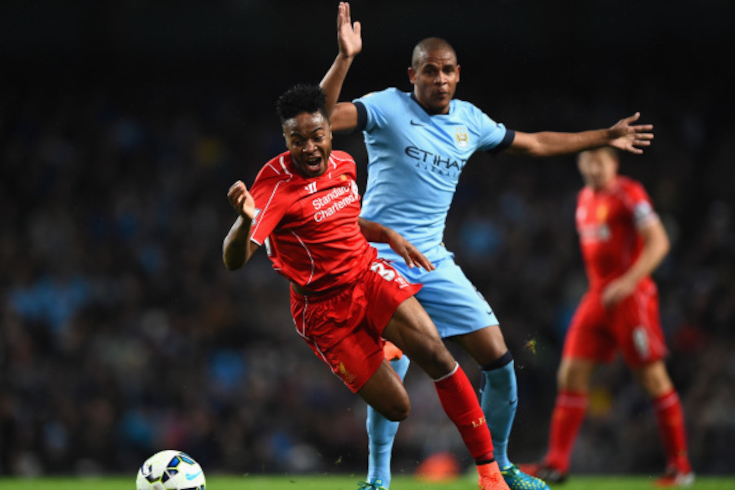 MANCHESTER, ENGLAND - AUGUST 25:  Raheem Sterling of Liverpool is challenged by Fernando Reges of Manchester City during the Barclays Premier League match between Manchester City and Liverpool at the Etihad Stadium on August 25, 2014 in Manchester, Englan