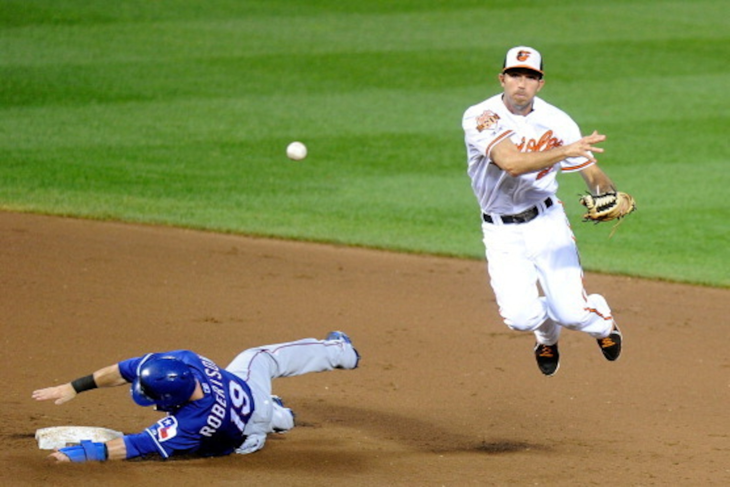 BALTIMORE, MD - JULY 01: J.J. Hardy #2 of the Baltimore Orioles forces out Dan Robertson #19 of the Texas Rangers to start a double play in the fifth inning at Oriole Park at Camden Yards on July 1, 2014 in Baltimore, Maryland.  (Photo by Greg Fiume/Getty
