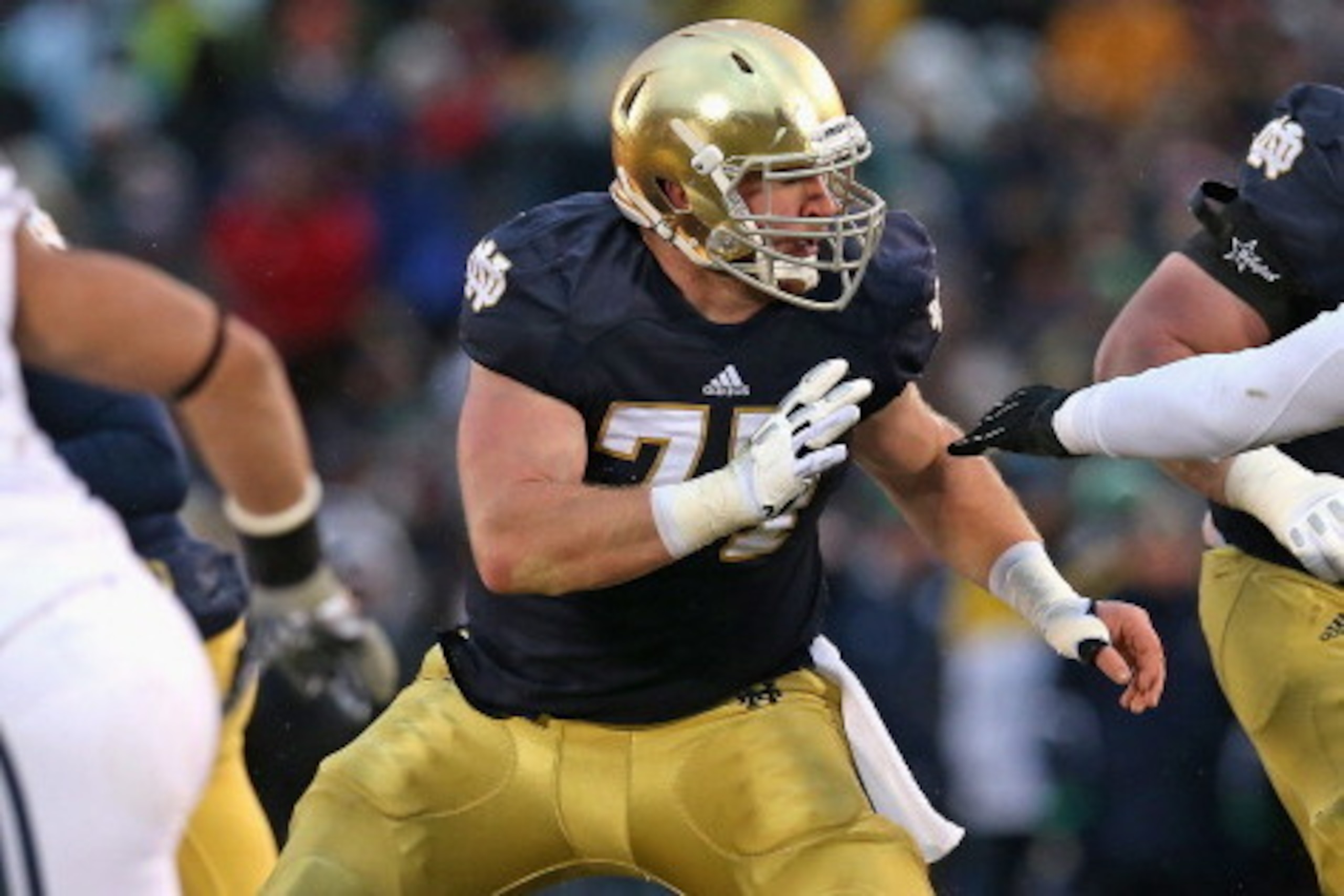 SOUTH BEND, IN - NOVEMBER 23: Matt Hegarty #77 of the Notre Dame Fighting Irish moves to block against the Brigham Young Cougars at Notre Dame Stadium on November 23, 2013 in South Bend, Indiana. Notre Dame defeated BYU 23-13. (Photo by Jonathan Daniel/Ge
