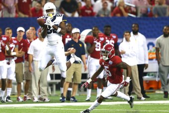 ATLANTA, GA - AUGUST 30:  Devonte Mathis #82 of the West Virginia Mountaineers pulls in this reception against Cyrus Jones #5 of the Alabama Crimson Tide at Georgia Dome on August 30, 2014 in Atlanta, Georgia.  (Photo by Martin Rose/Getty Images)