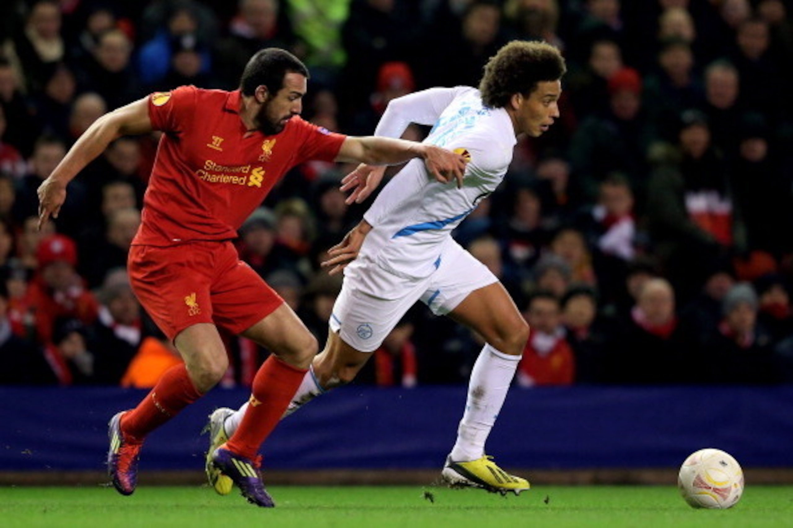 LIVERPOOL, ENGLAND - FEBRUARY 21:  Axel Witsel of Zenit goes past Jose Enrique of Liverpool during the UEFA Europa League round of 32 second leg match between Liverpool FC and FC Zenit St Petersburg at Anfield on February 21, 2013 in Liverpool, England.  