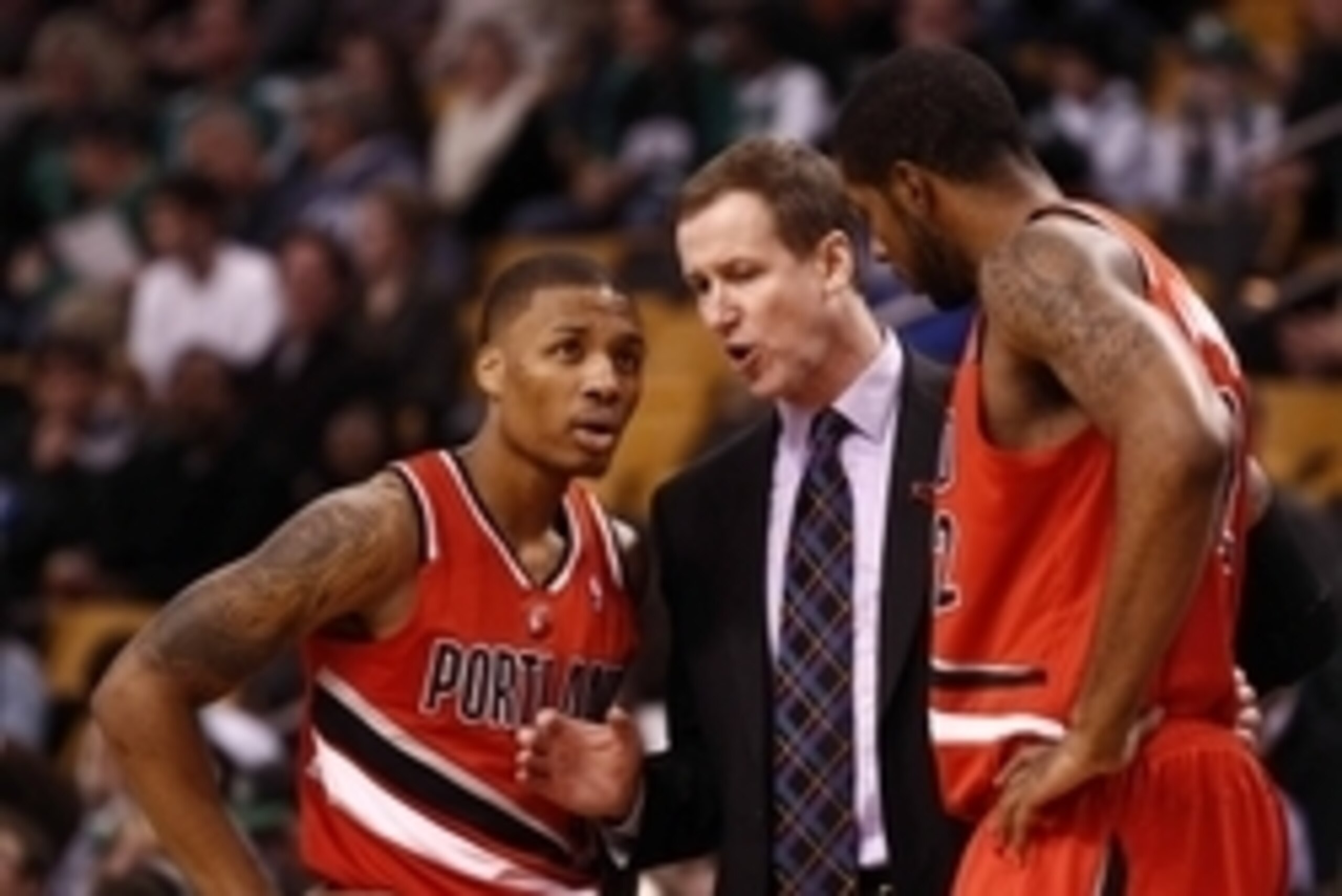 Nov 30, 2012; Boston, MA, USA; Portland Trail Blazers head coach Terry Stotts (center) speaks with Portland Trail Blazers point guard Damian Lillard (left) and power forward LaMarcus Aldridge (right) during the first half of a game against the Boston Celt