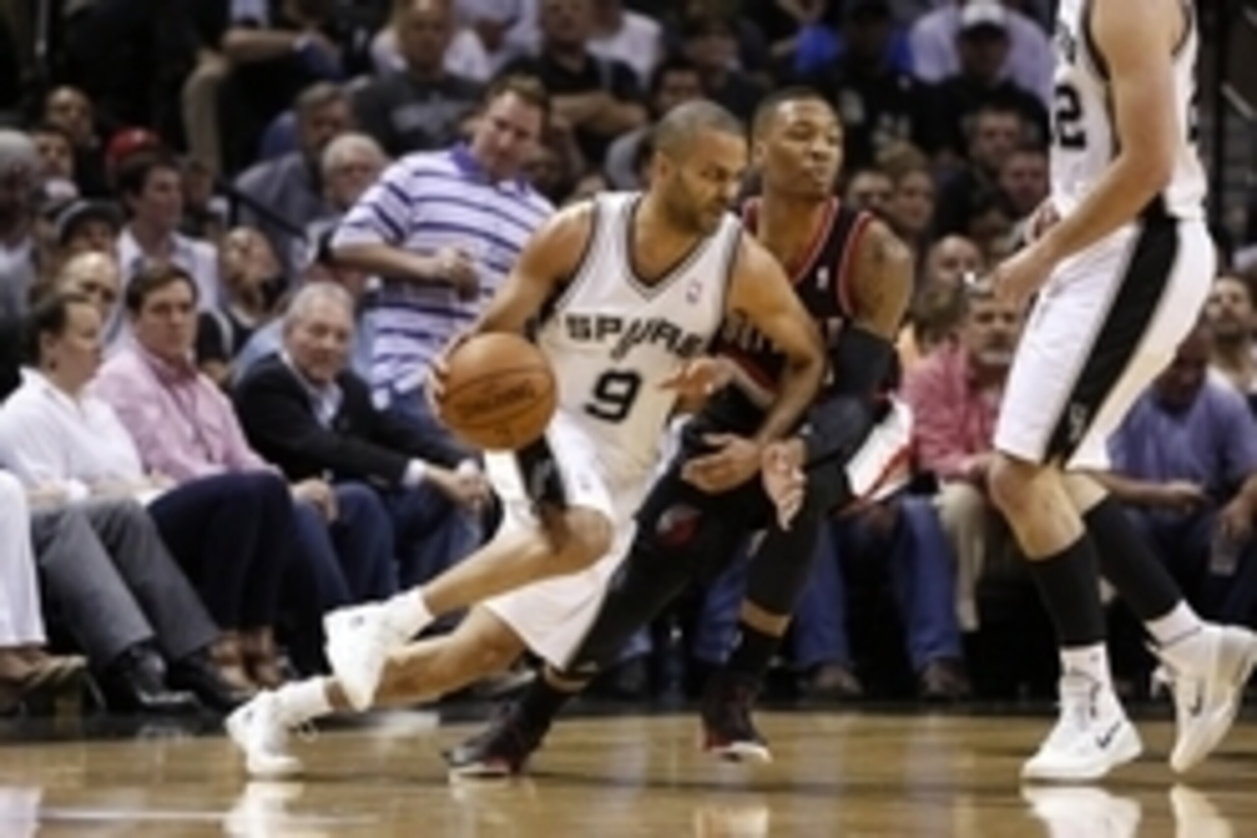 May 6, 2014; San Antonio, TX, USA; San Antonio Spurs guard Tony Parker (9) moves the ball against the defense of Portland Trail Blazers guard Damian Lillard (0) in game one of the second round of the 2014 NBA Playoffs at AT&T Center. Mandatory Credit: Soo