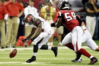 ATLANTA, GA - SEPTEMBER 18: Running back Bobby Rainey #43 of the Tampa Bay Buccaneers fumbles as inside linebacker Joplo Bartu #59 of the Atlanta Falcons defends during a game at the Georgia Dome on September 18, 2014 in Atlanta, Georgia.  (Photo by Scott