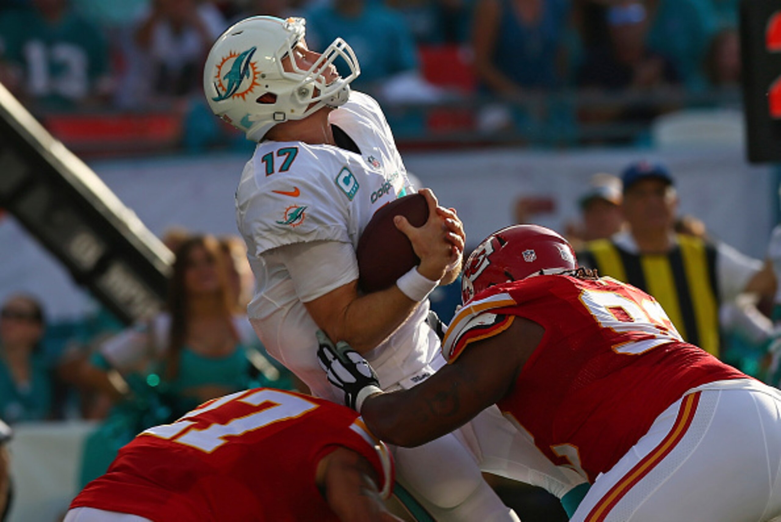 MIAMI GARDENS, FL - SEPTEMBER 21:  Quarterback Ryan Tannehill #17 of the Miami Dolphins is brought down by the Kansas City Chiefs defense in the second quarter of their game at Sun Life Stadium on September 21, 2014 in Miami Gardens, Florida.  (Photo by R