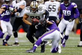 NEW ORLEANS, LA - SEPTEMBER 21:  Jimmy Graham #80 of the New Orleans Saints avoids a tackle by Josh Robinson #21 of the Minnesota Vikings during the first quarter of a game at the Mercedes-Benz Superdome on September 21, 2014 in New Orleans, Louisiana.  (