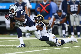 ST. LOUIS, MO - SEPTEMBER 21: Janoris Jenkins #21 of the St. Louis Rams tackles Dez Bryant #88 of the Dallas Cowboys in the first quarter at the Edward Jones Dome on September 21, 2014 in St. Louis, Missouri.  The Cowboys beat the Rams 34-31.  (Photo by D