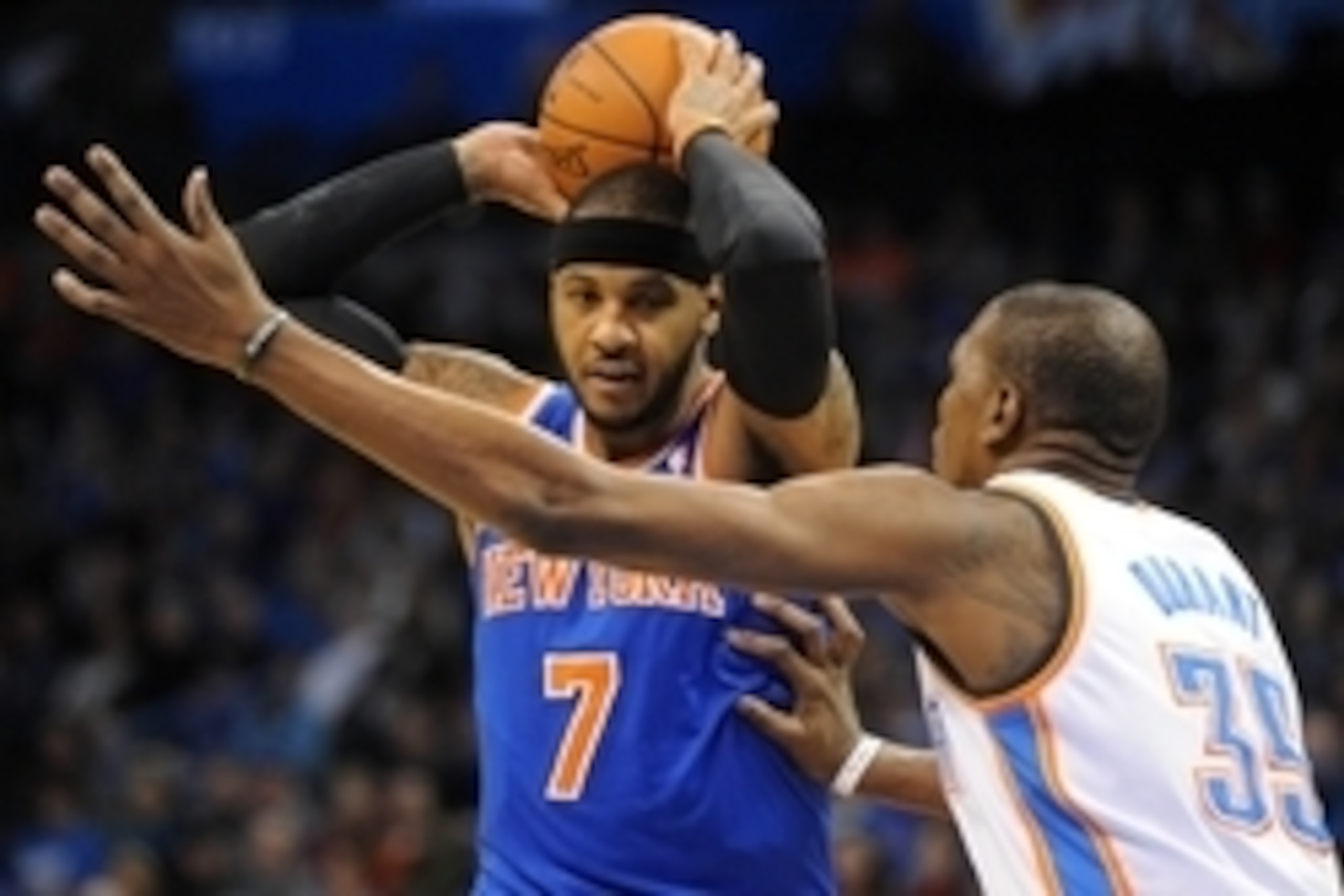 Feb 9, 2014; Oklahoma City, OK, USA; New York Knicks small forward Carmelo Anthony (7) holds the ball as Oklahoma City Thunder small forward Kevin Durant (35) defends during the first quarter at Chesapeake Energy Arena. Mandatory Credit: Mark D. Smith-USA