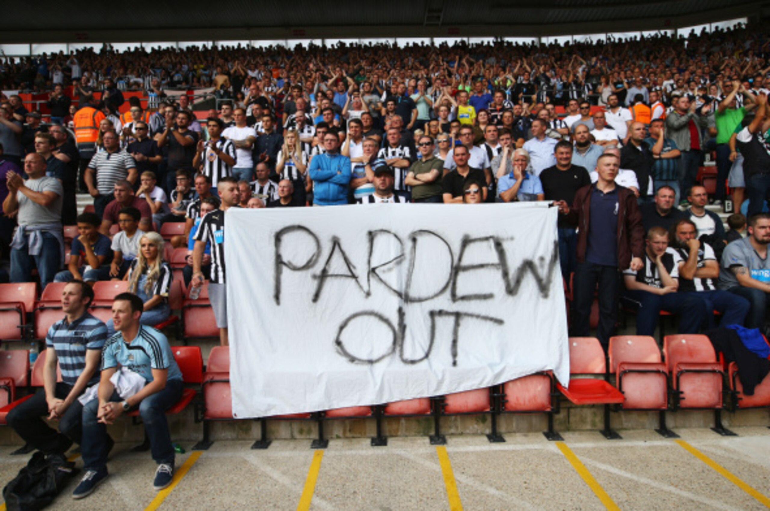 SOUTHAMPTON, ENGLAND - SEPTEMBER 13:  Newcastle United fans hold a 'Pardew Out' banner during the Barclays Premier League match between Southampton and Newcastle United at St Mary's Stadium on September 13, 2014 in Southampton, England.  (Photo by Richard