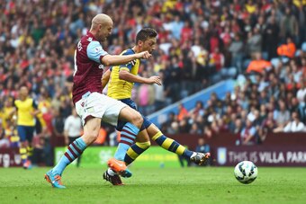 BIRMINGHAM, ENGLAND - SEPTEMBER 20:  Mesut Oezil of Arsenal scores the opening goal during the Barclays Premier League match between Aston Villa and Arsenal at Villa Park on September 20, 2014 in Birmingham, England.  (Photo by Laurence Griffiths/Getty Im