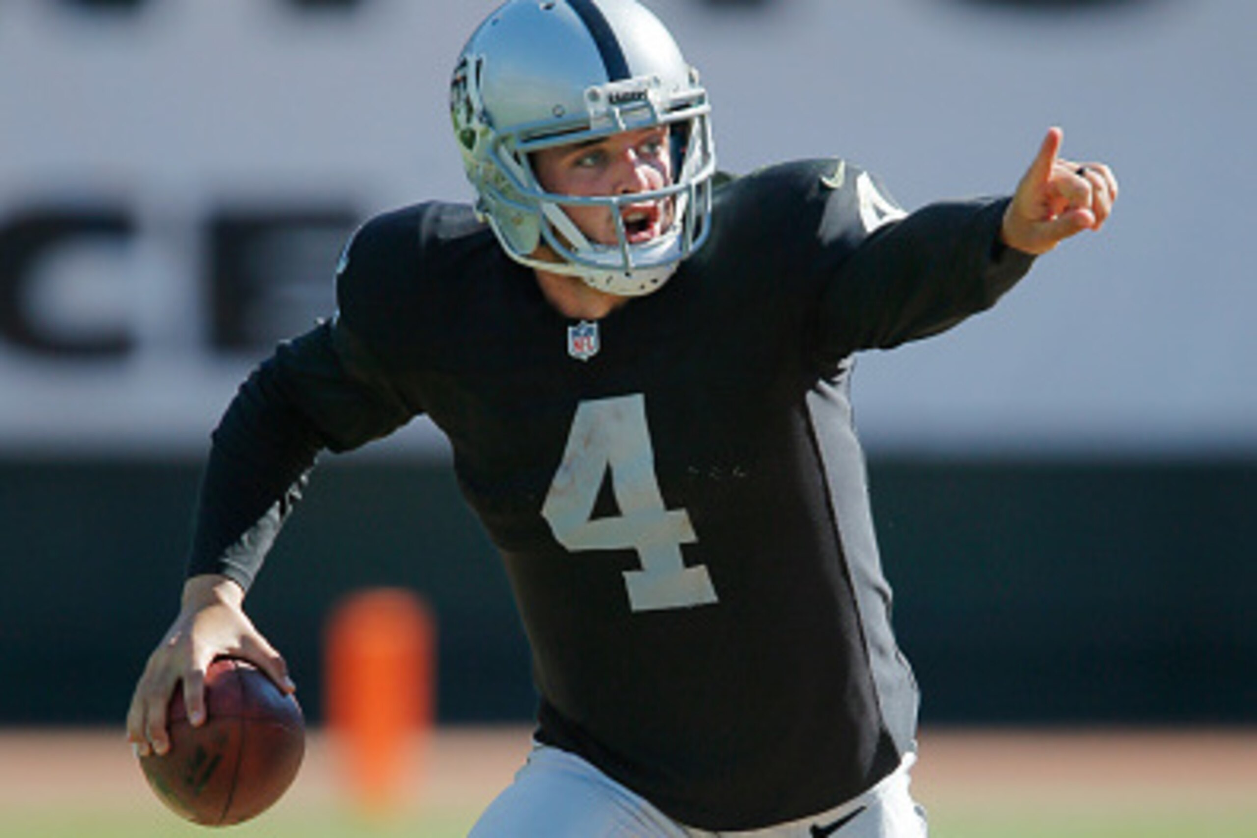 OAKLAND, CA - SEPTEMBER 14:  Quarterback Derek Carr #4 of the Oakland Raiders looks for a receiver against the Houston Texans with under a minute left in the fourth quarter on September 14, 2014 at O.co Coliseum in Oakland, California.  The Texans won 30-