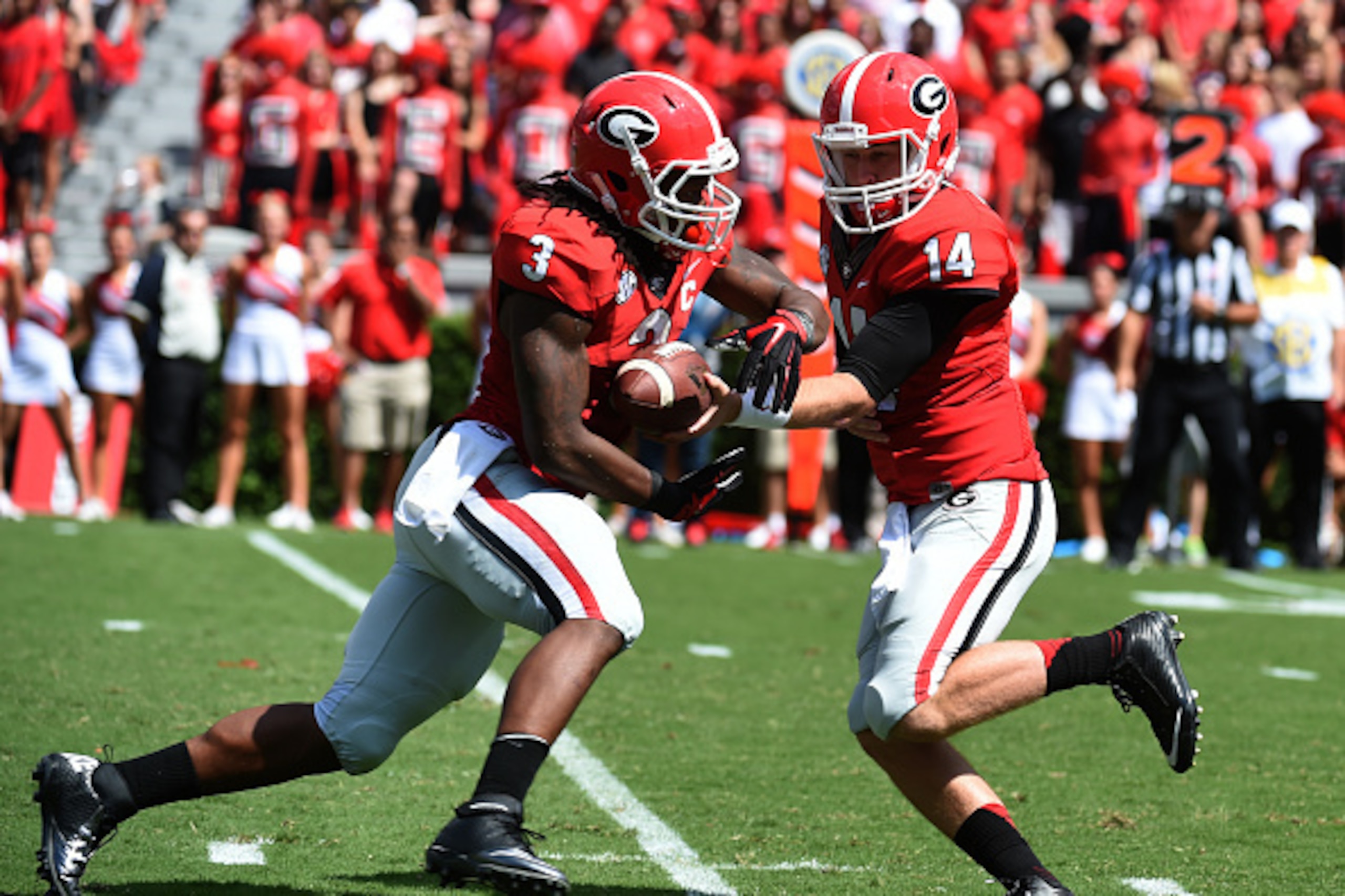 ATHENS, GA - SEPTEMBER 20: Todd Gurley #3 of the Georgia Bulldogs takes a handoff from Hutson Mason #14 during the game against the Troy Trojans at Sanford Stadium on September 20, 2014 in Athens, Georgia. (Photo by Scott Cunningham/Getty Images)