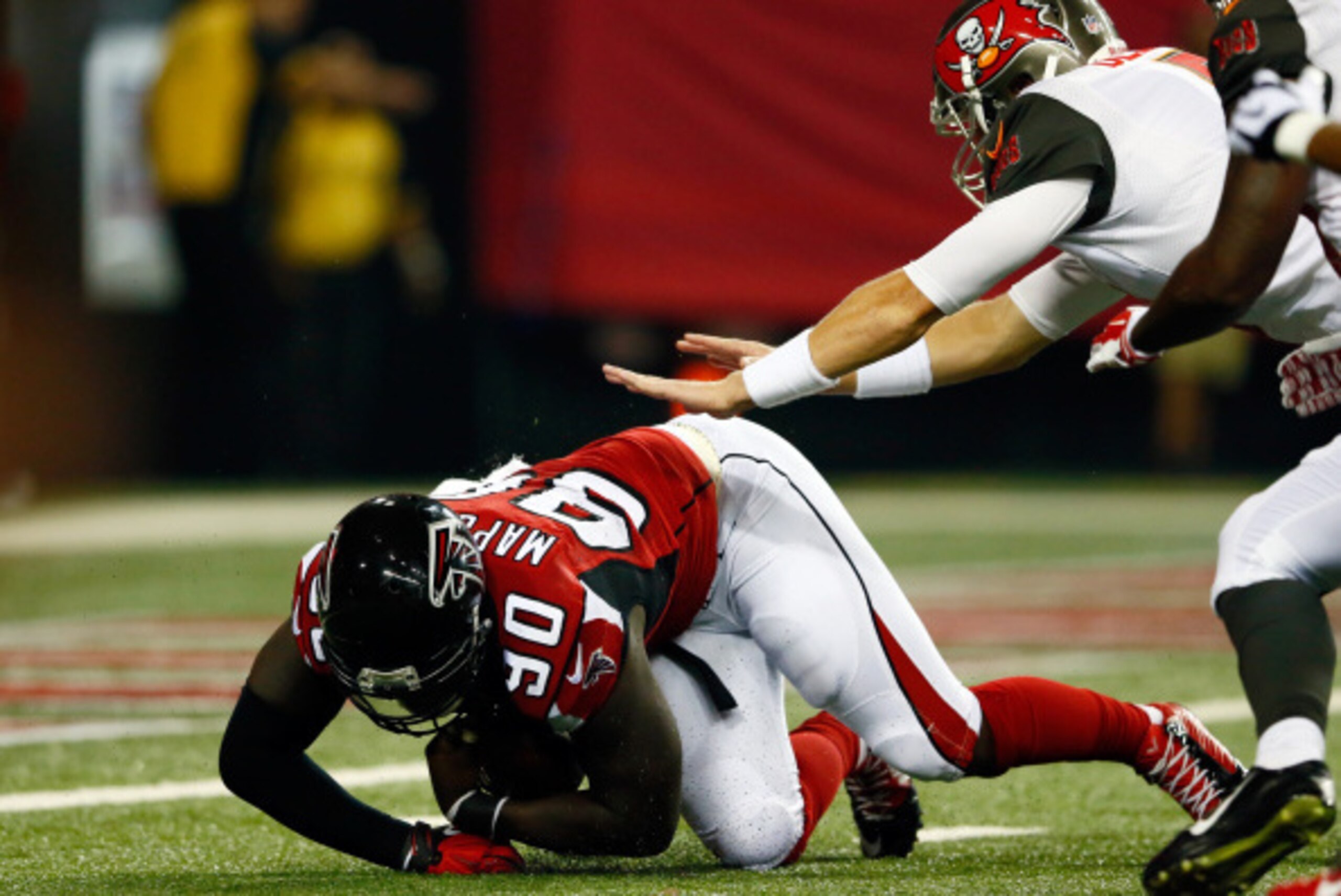 ATLANTA, GA - SEPTEMBER 18: Defensive end Stansly Maponga #90 of the Atlanta Falcons recovers a loose ball against quarterback Mike Glennon #8 of the Tampa Bay Buccaneers during a game at the Georgia Dome on September 18, 2014 in Atlanta, Georgia.  (Photo