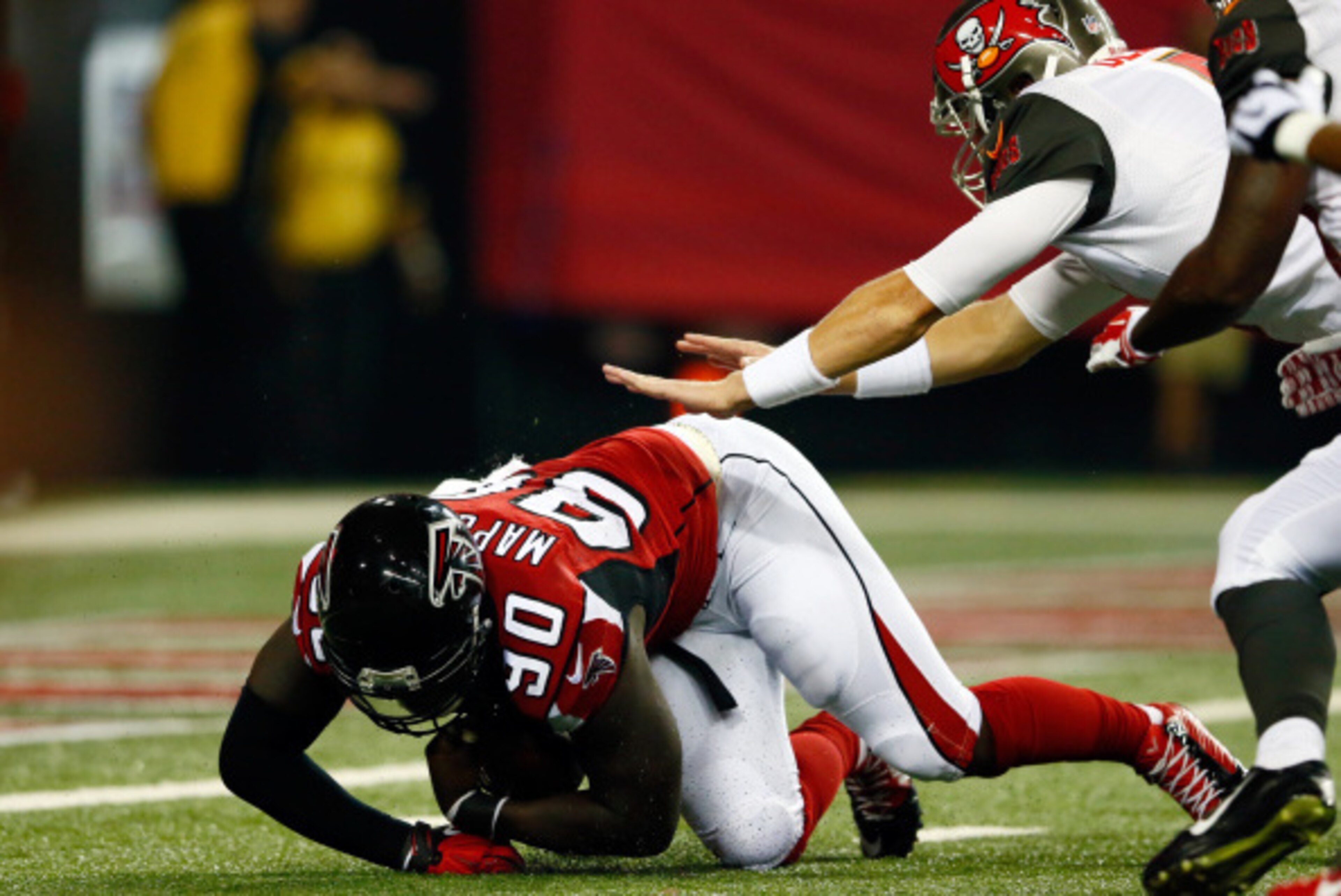 ATLANTA, GA - SEPTEMBER 18: Defensive end Stansly Maponga #90 of the Atlanta Falcons recovers a loose ball against quarterback Mike Glennon #8 of the Tampa Bay Buccaneers during a game at the Georgia Dome on September 18, 2014 in Atlanta, Georgia.  (Photo