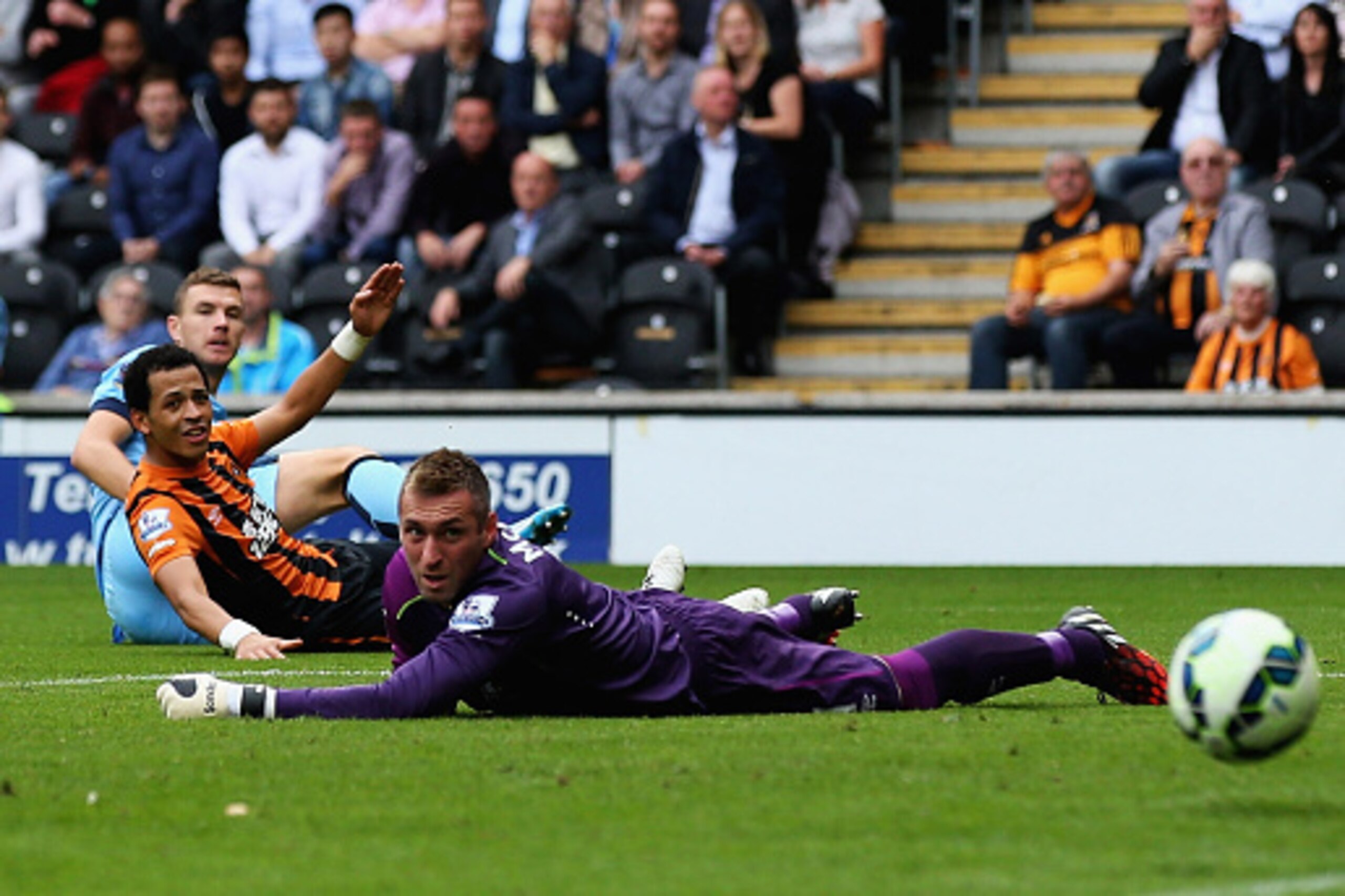 HULL, ENGLAND - SEPTEMBER 27:  Edin Dzeko of Manchester City scores his team's third goal past Allan McGregor of Hull City during the Barclays Premier League match between Hull City and Manchester City at KC Stadium on September 27, 2014 in Hull, England.