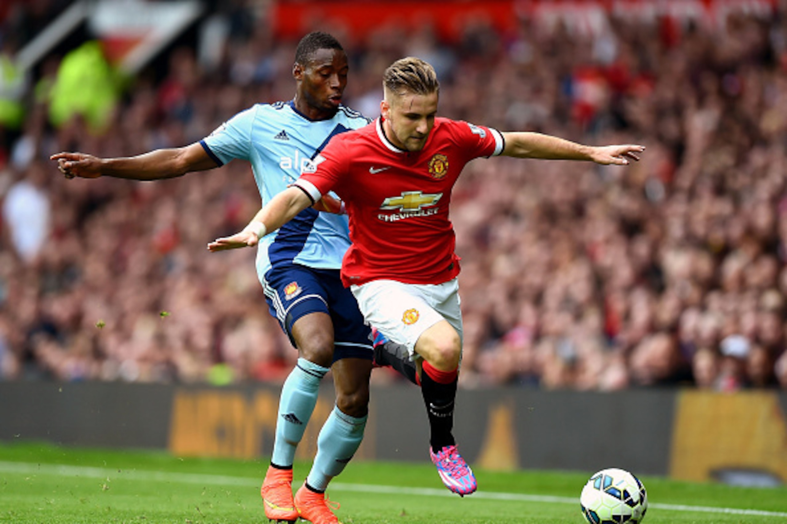 MANCHESTER, ENGLAND - SEPTEMBER 27: Luke Shaw of Manchester United goes past the challenge from Diafra Sakho of West Ham during the Barclays Premier League match between Manchester United and West Ham United at Old Trafford on September 27, 2014 in Manch MANCHESTER, ENGLAND - SEPTEMBER 27: Luke Shaw of Manchester United goes past the challenge from Diafra Sakho of West Ham during the Barclays Premier League match between Manchester United and West Ham United at Old Trafford on September 27, 2014 in Manch