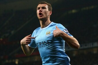MANCHESTER, ENGLAND - MARCH 25:  Edin Dzeko of Manchester City celebrates scoring the second goal during the Barclays Premier League match between Manchester United and Manchester City at Old Trafford on March 25, 2014 in Manchester, England.  (Photo by A