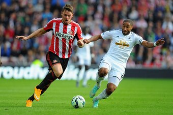 SUNDERLAND, ENGLAND - SEPTEMBER 27:  Swansea player Ashley Williams (r) challenges Connor Wickham of Sunderland during the Barclays Premier League match between Sunderland and Swansea City at Stadium of Light on September 27, 2014 in Sunderland, England. 