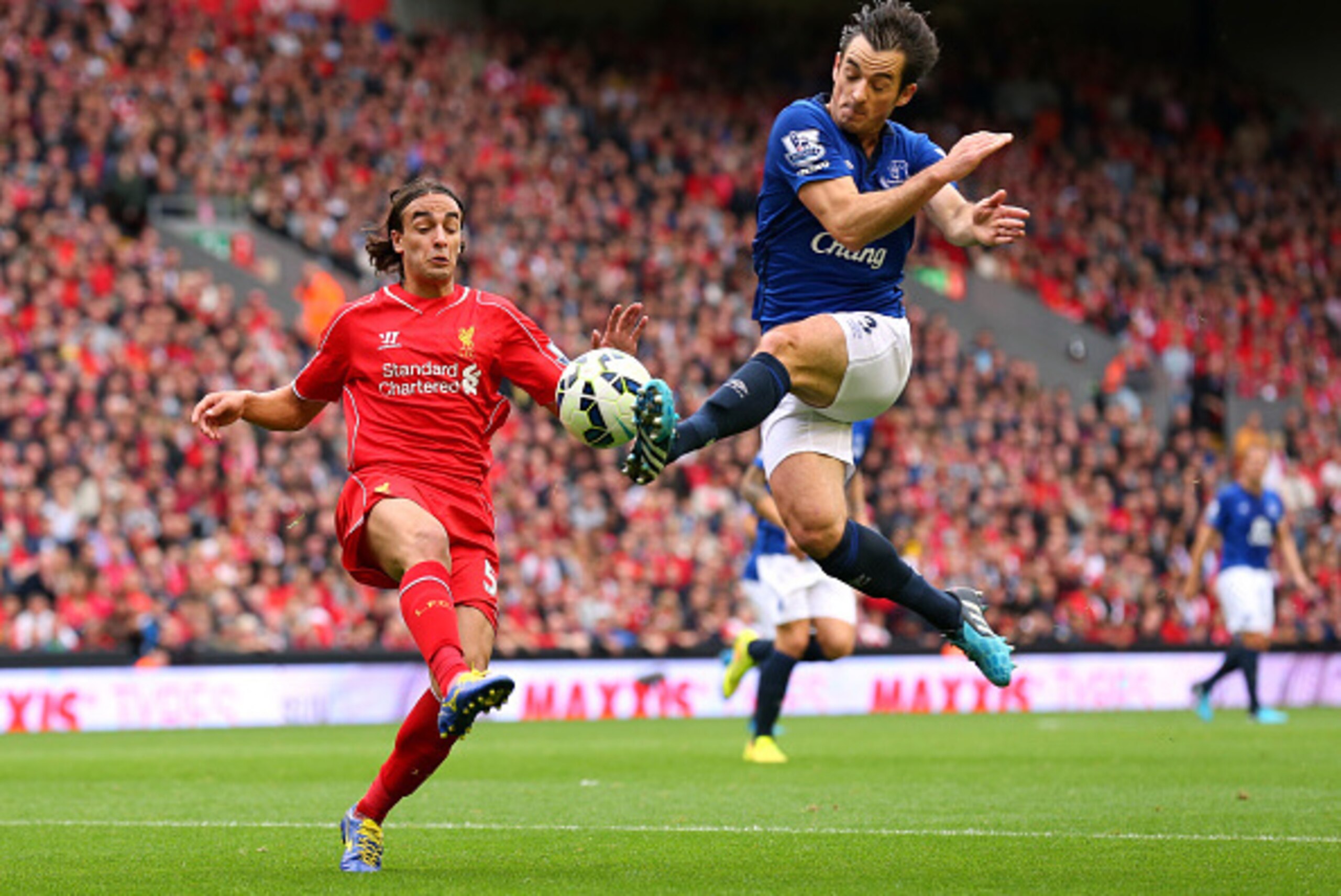 LIVERPOOL, ENGLAND - SEPTEMBER 27:  Leighton Baines of Everton tackles Lazar Markovic of Liverpool during the Barclays Premier League match between Liverpool and Everton at Anfield on September 27, 2014 in Liverpool, England.  (Photo by Alex Livesey/Getty