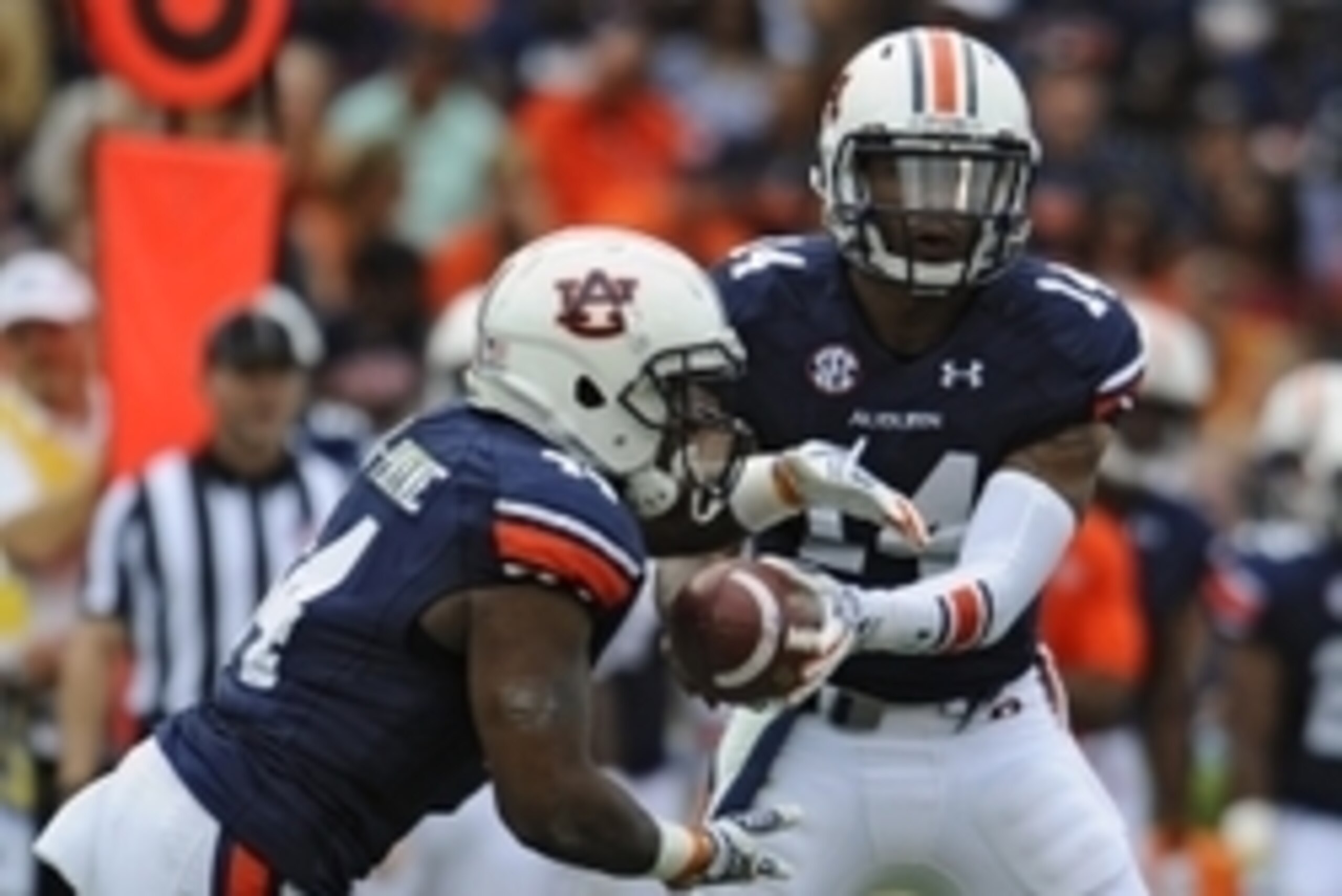 Sep 27, 2014; Auburn, AL, USA; Auburn Tigers quarterback Nick Marshall (14) hands the ball off to running back Cameron Artis-Payne (44) during the first half against the Louisiana Tech Bulldogs at Jordan Hare Stadium. Mandatory Credit: Shanna Lockwood-USA