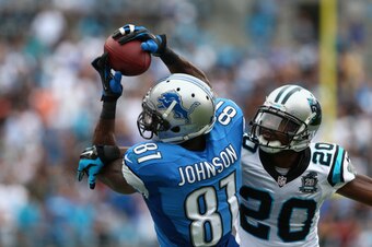 CHARLOTTE, NC - SEPTEMBER 14:  Calvin Johnson #81 of the Detroit Lions catches the ball against  Antoine Cason #20 of the Carolina Panthers during the game at Bank of America Stadium on September 14, 2014 in Charlotte, North Carolina.  (Photo by Streeter 