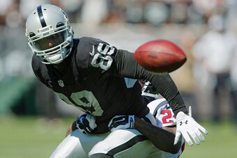 OAKLAND, CA - SEPTEMBER 14:  Wide receiver James Jones #89 of the Oakland Raiders turns the ball over for the second time after recovering his first fumble as he gets tackled a second time by cornerback Johnathan Joseph #24 of the Houston Texans in the se