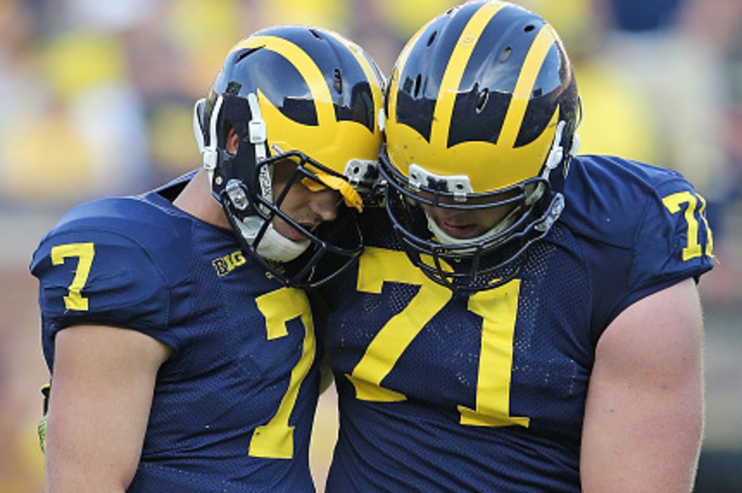 ANN ARBOR, MI - SEPTEMBER 27: Quarterback Shane Morris #7 of the Michigan Wolverines is helped off the field by Ben Braden #71 during the fourth quarter of the game against the Minnesota Golden Gophers at Michigan Stadium on September 27, 2014 in Ann Arbo