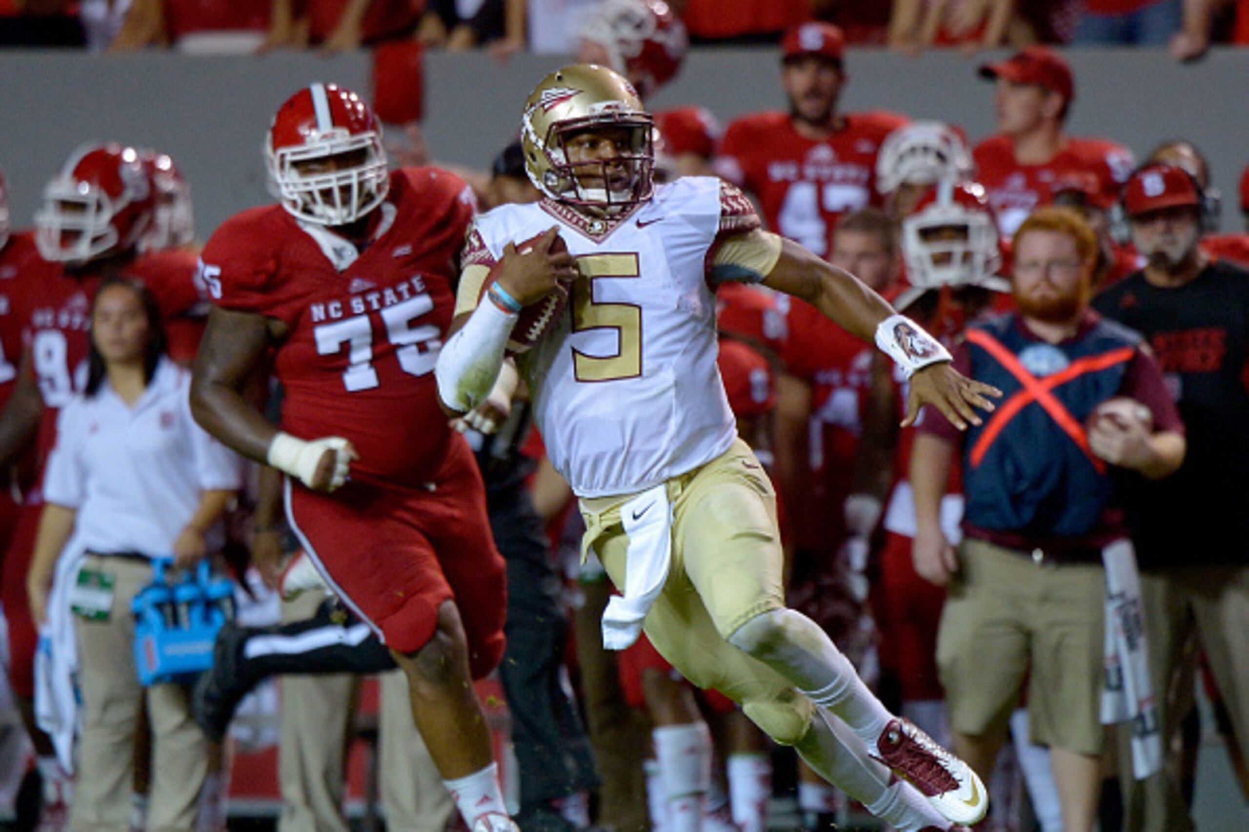 RALEIGH, NC - SEPTEMBER 27:  Jameis Winston #5 of the Florida State Seminoles converts on third-and-11 late in the fourth quarter of their game against the North Carolina State Wolfpack at Carter-Finley Stadium on September 27, 2014 in Raleigh, North Caro