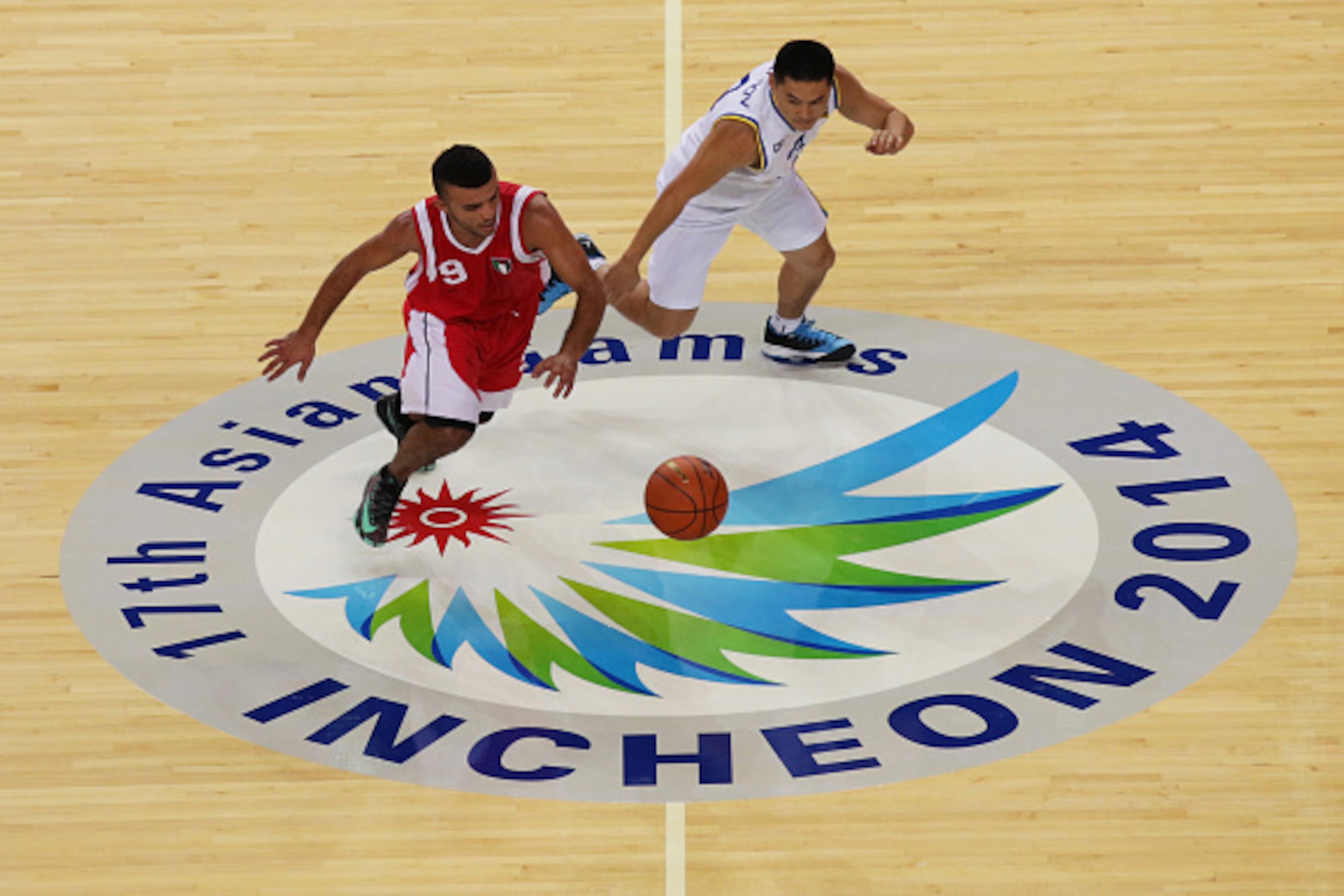 INCHEON, SOUTH KOREA - SEPTEMBER 21:  Amin Salman of Palestine competes for the ball with Timur Sultanov of Kazakhstan in the Qualifying Round-group B at Samsan World Gymnasium during the 2014 Asian Games at  on September 21, 2014 in Incheon, South Korea.